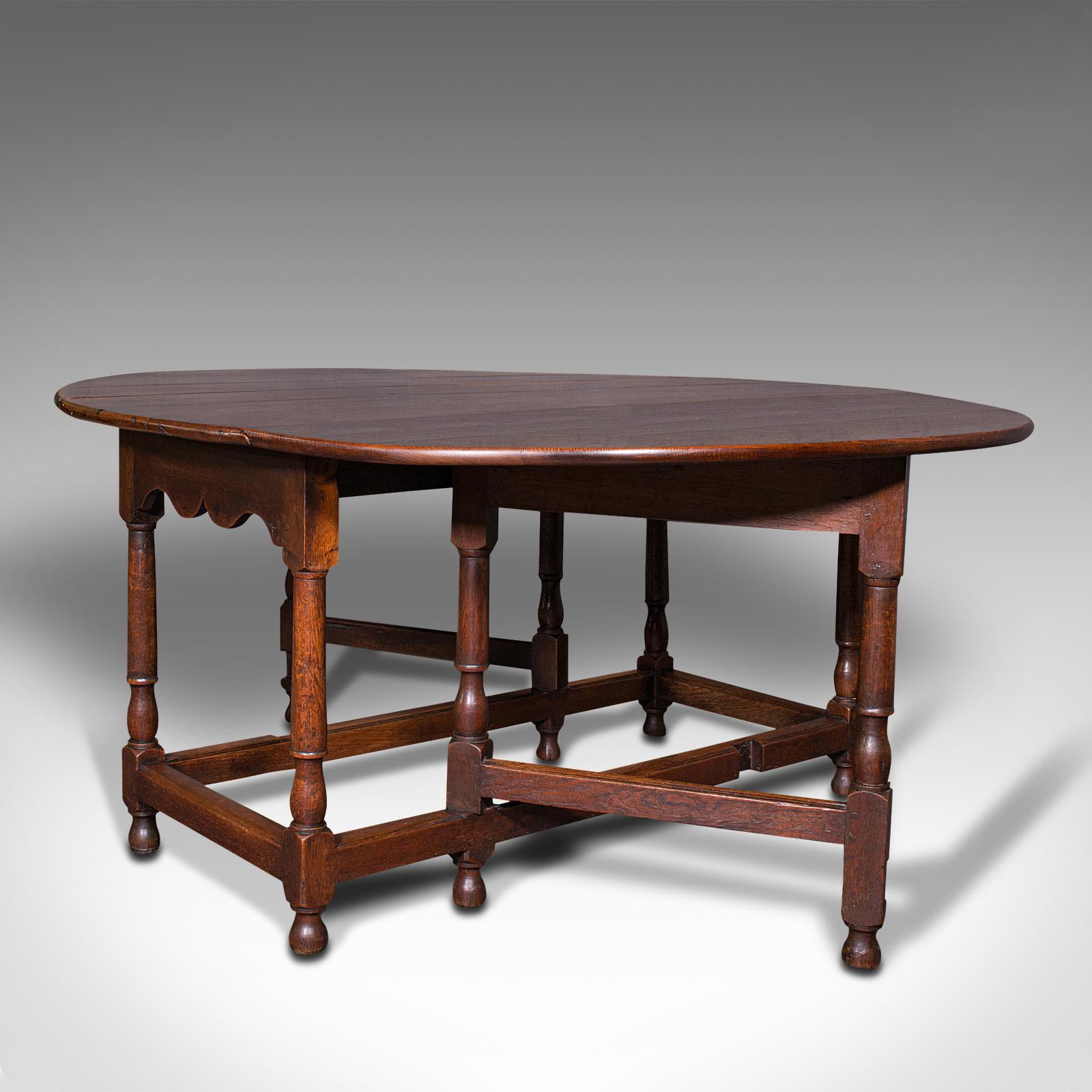 This is a large antique gate-leg table. An English, oak fold over occasional table, dating to the late Victorian period, circa 1900.

Graced with exquisite figuring and colour
Displays a desirable aged patina and in very good order
Antique