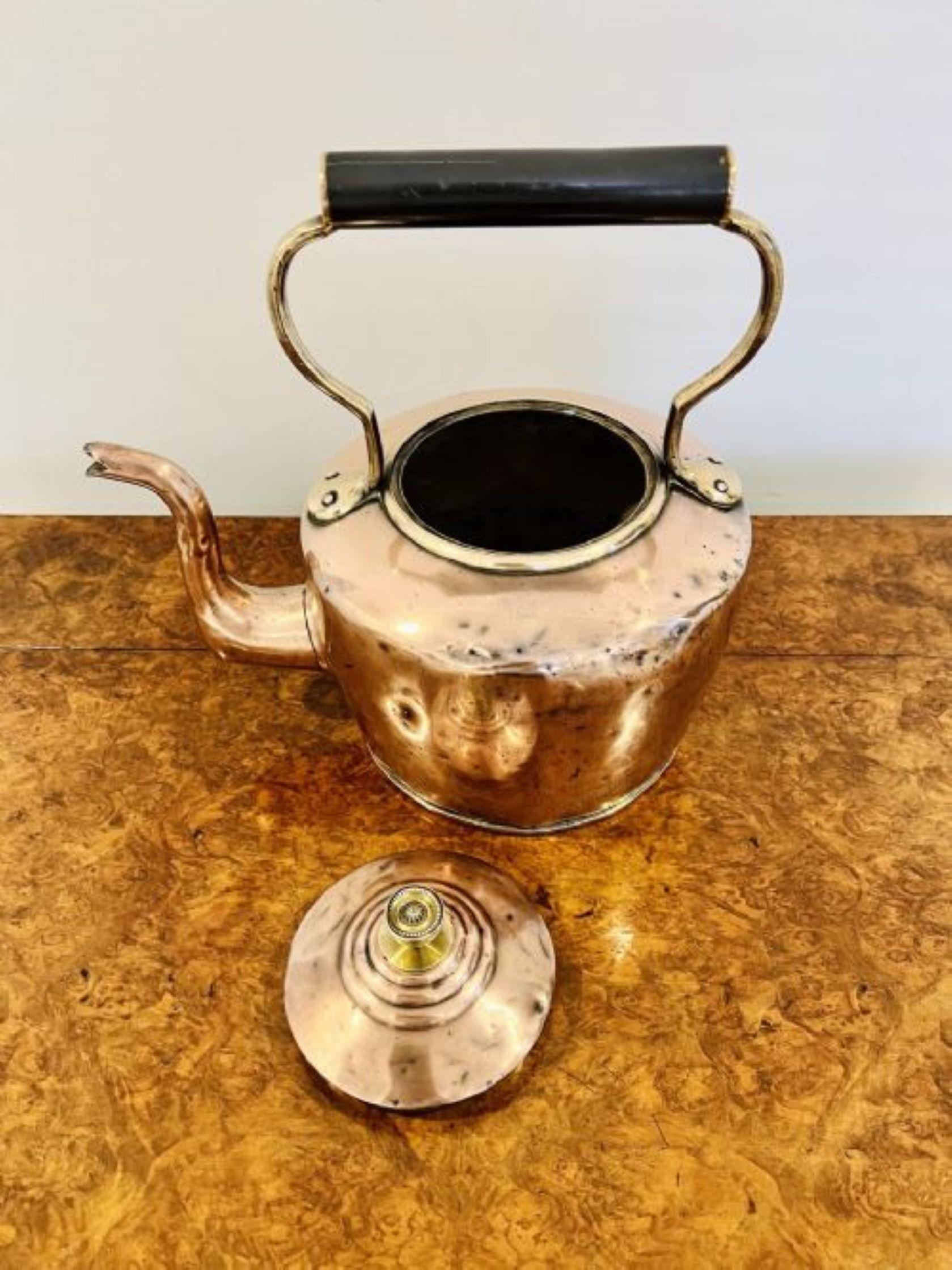 Large antique George III copper kettle having a shaped handle and spout, lift off lid with the original original ornate brass knob.