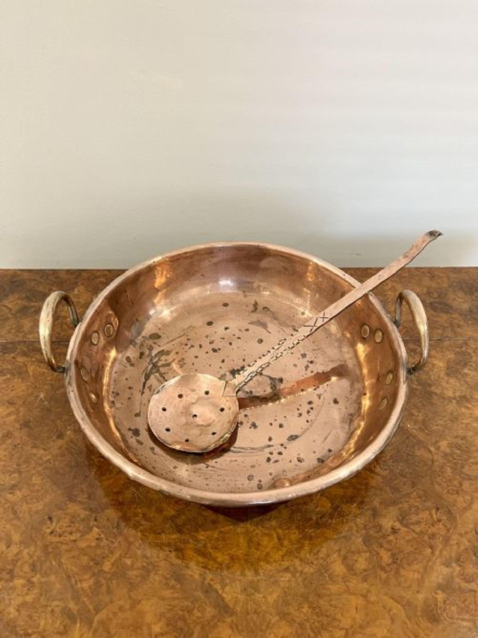 Large antique George III quality copper pan with shaped handles to both sides and a antique copper skimmer 

D. 1820