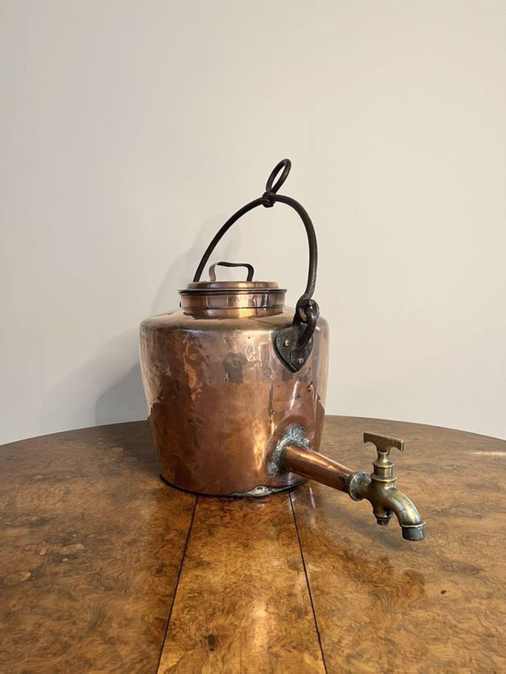 Large antique George III quality hanging copper water urn, having the original iron swing handle to the top above a large quality copper urn, with a lift off lid, a copper spout and brass tap.

D. 1800