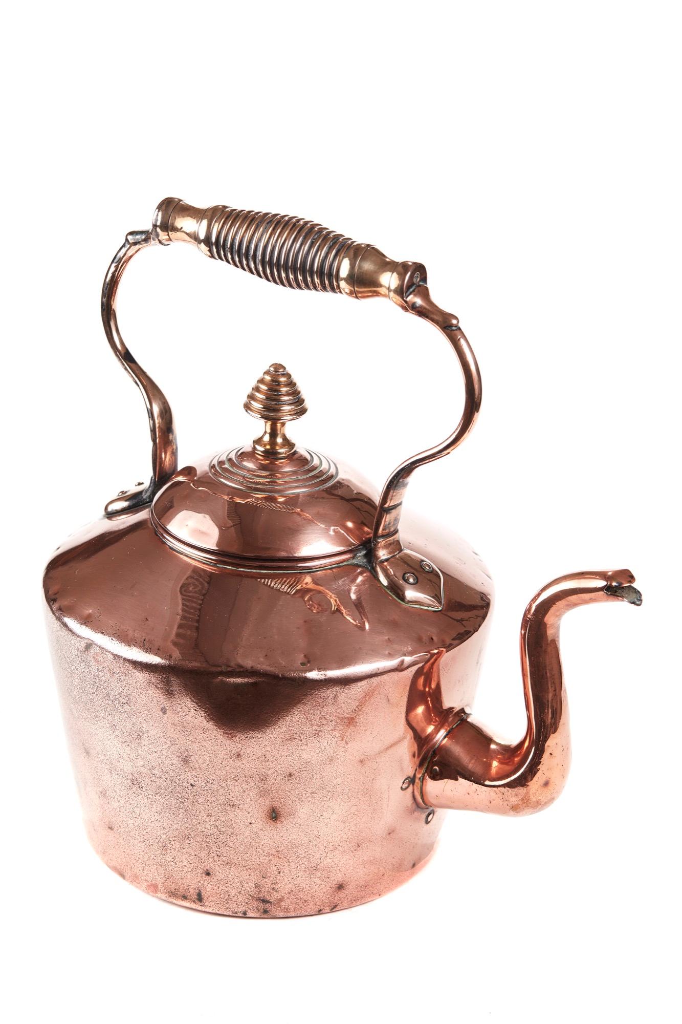 This is a large Georgian antique copper Kettle with an unusual shaped handle with lift off lid. Traditional shaped spout. 

It is in a very lovely antique condition.

H36cm
W27cm
D27cm
Height of body 15cm
Georgian.
 