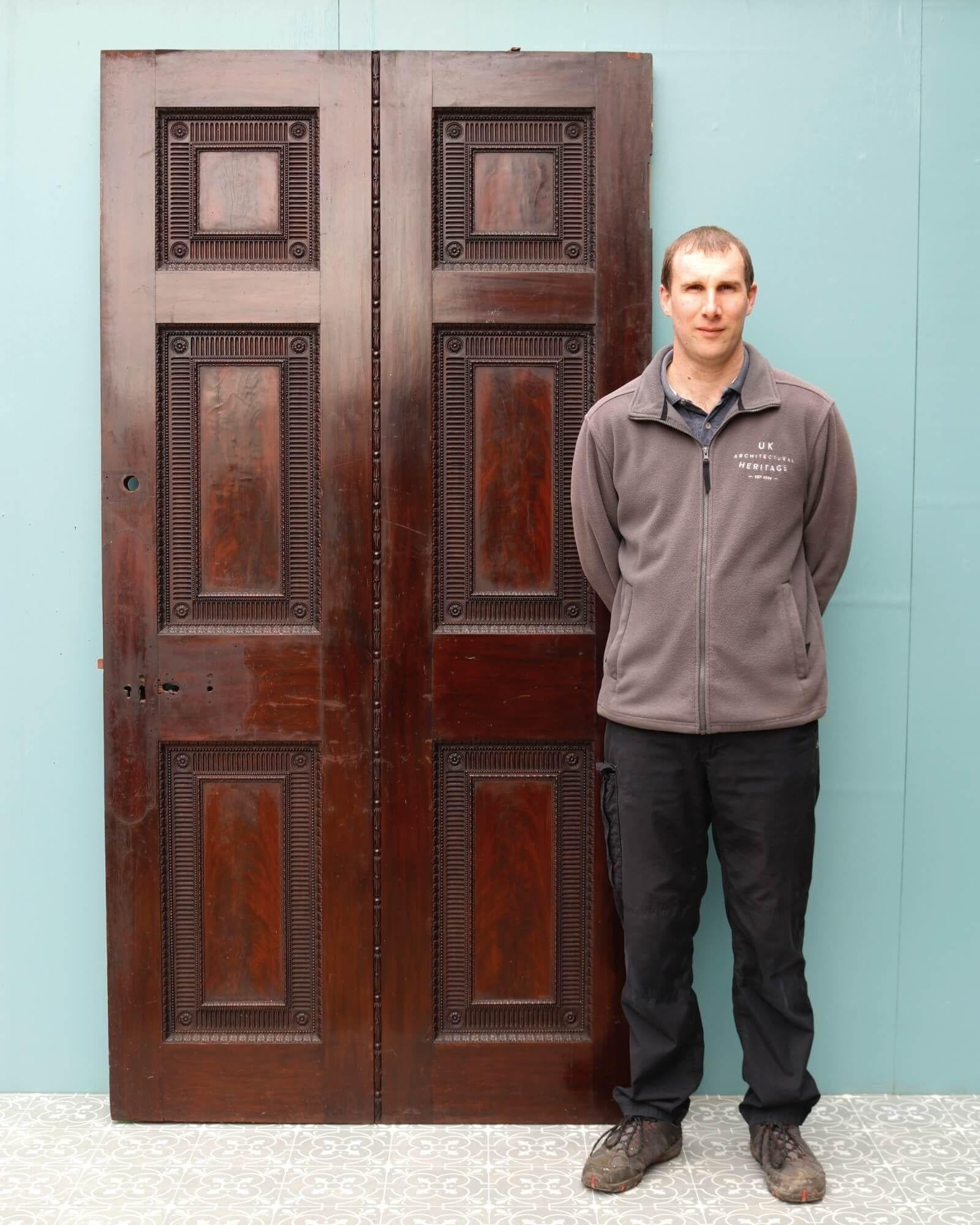 A very large Georgian mahogany door, sourced from an English country house, suitable for exterior or interior use. At over 200 years old and showcasing a handsome warm mahogany colour, this impressive reclaimed door has stood the test of time and