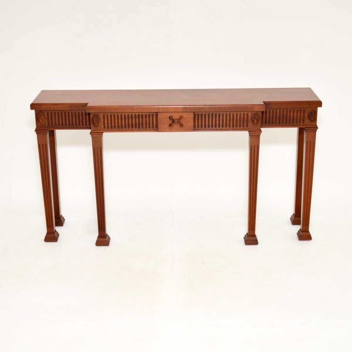 An outstanding large antique console table, made in England and dating from around the 1930’s period.

It is of the utmost quality, crafted from absolutely gorgeous wood. It is a large and impressive size, with a breakfront design to the front.