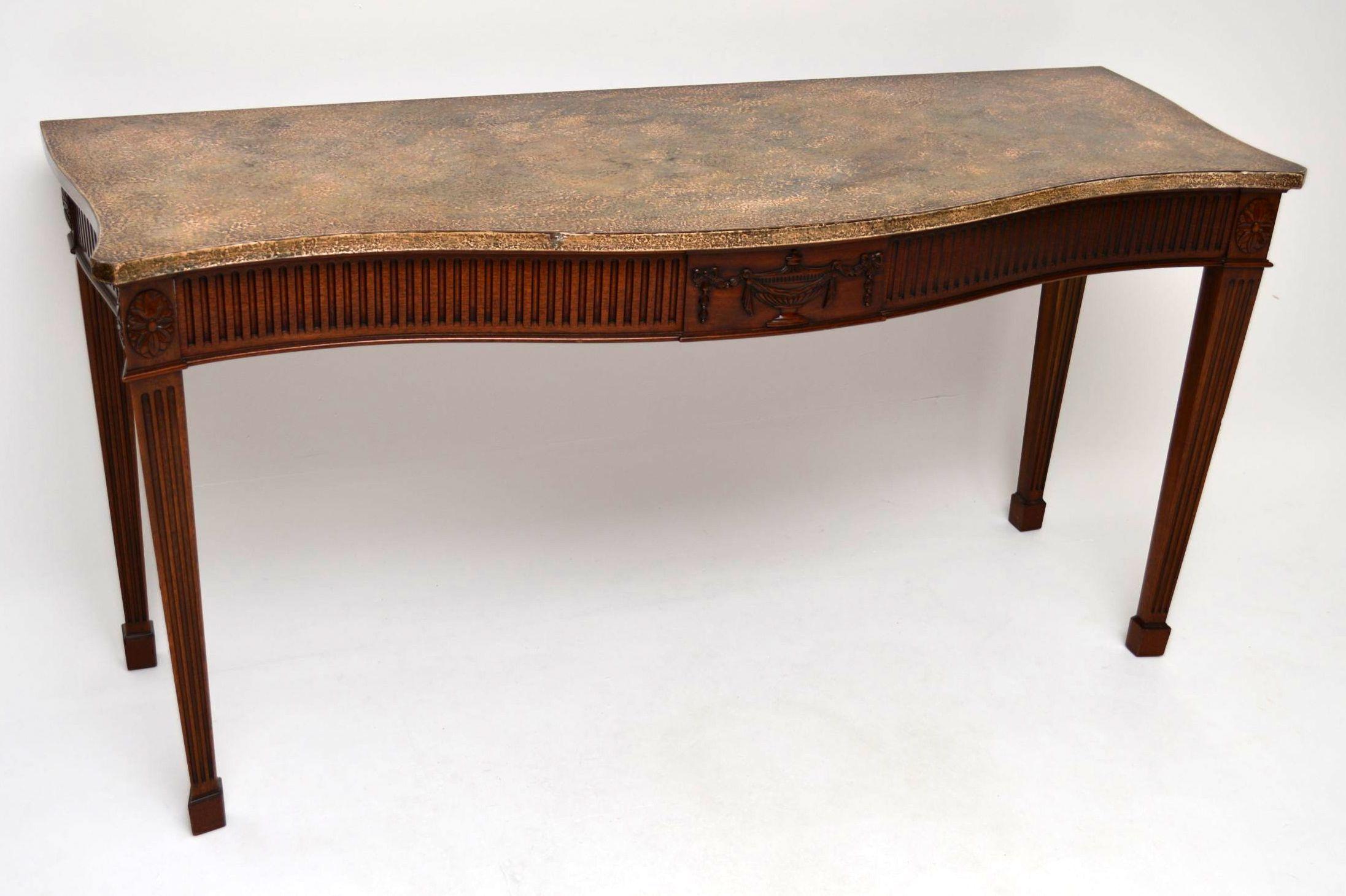 Very long solid mahogany console side table in mahogany, with a very unusual top which looks like stone, but isn't. The top must have been made with the rest of the table & it is fixed on. It was made to look like marble or some kind of stone &