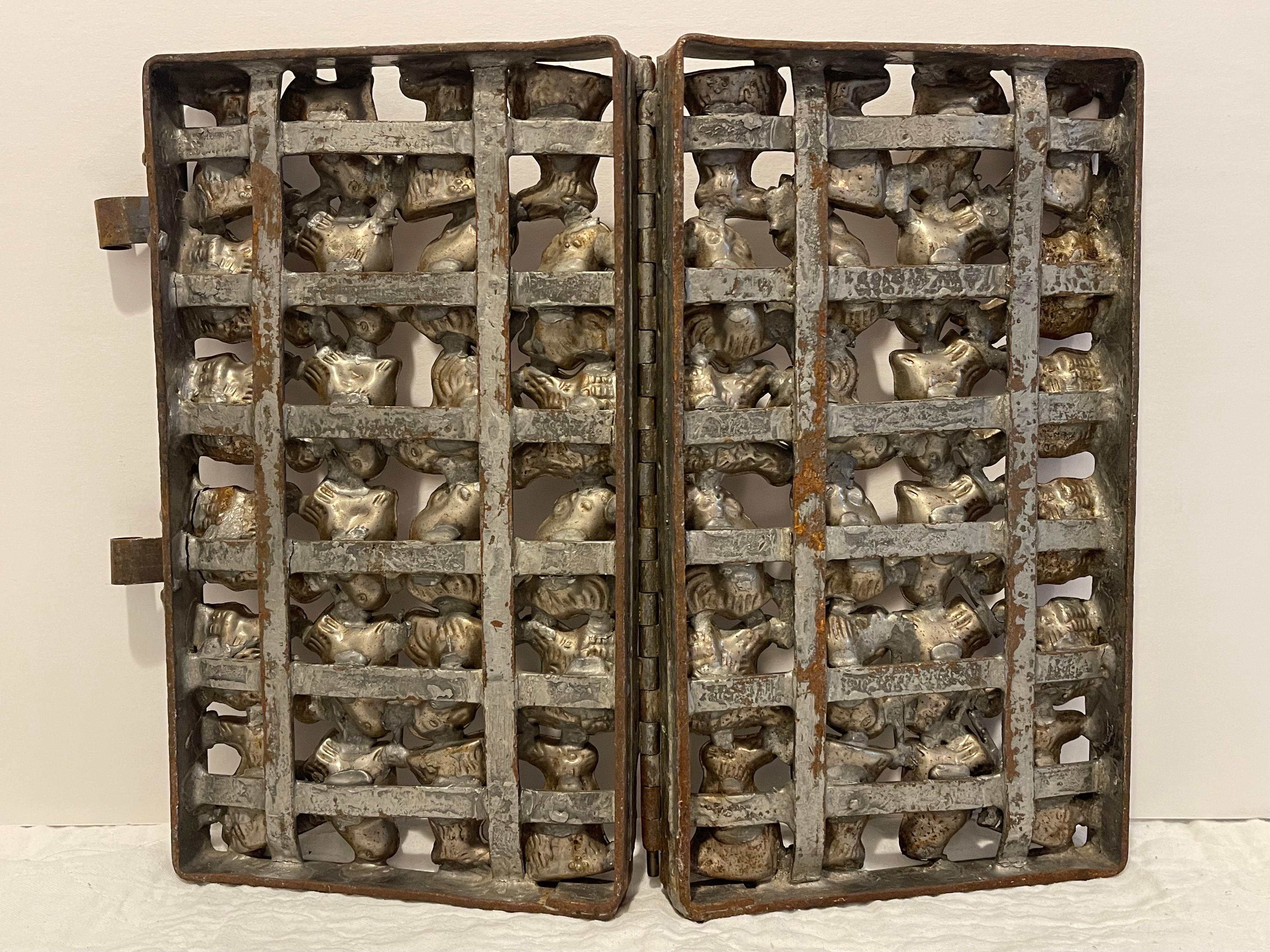 Large Antique German Chocolate Mold with Bunnies and Chickens. Nice hinged double door German chocolate mold. The molds themselves have bunnies and hens. Nice Patina to this beauty.