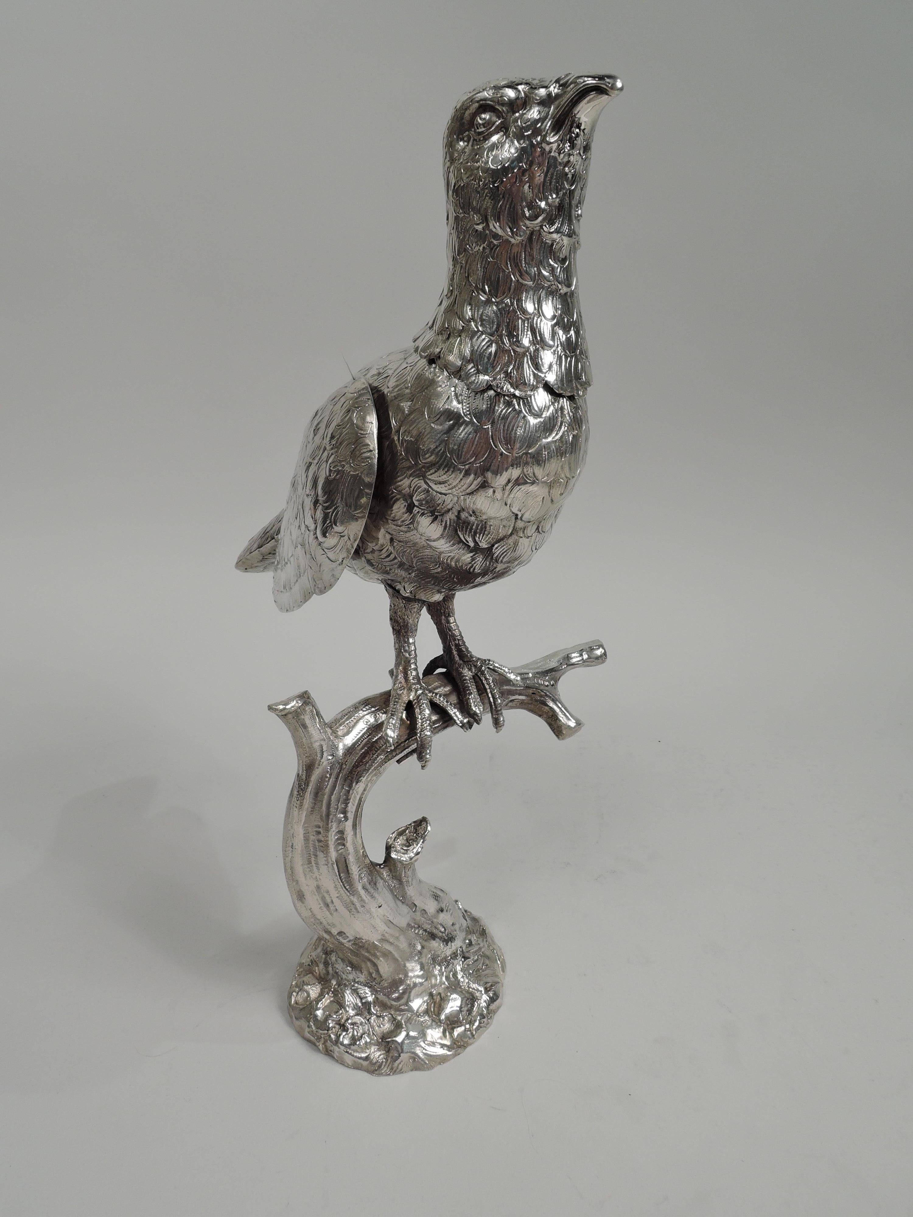 Large turn-of-the-century German 800 silver figural spice box. A bird grips a gnarly branch with scaly talons. Sweet and downy with tucked-down wings. Head detachable. Marked. Weight: 27 troy ounces.