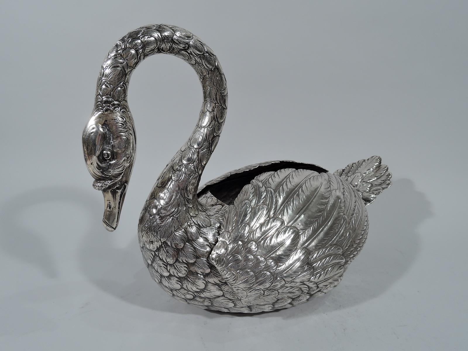 Delightful antique German sterling silver swan. A big bird with scrolled neck terminating in closed bill and erect tail feathers. Finely engraved feathers and hinged plumy wings that can be opened to suggest flight. A fabulous centerpiece with
