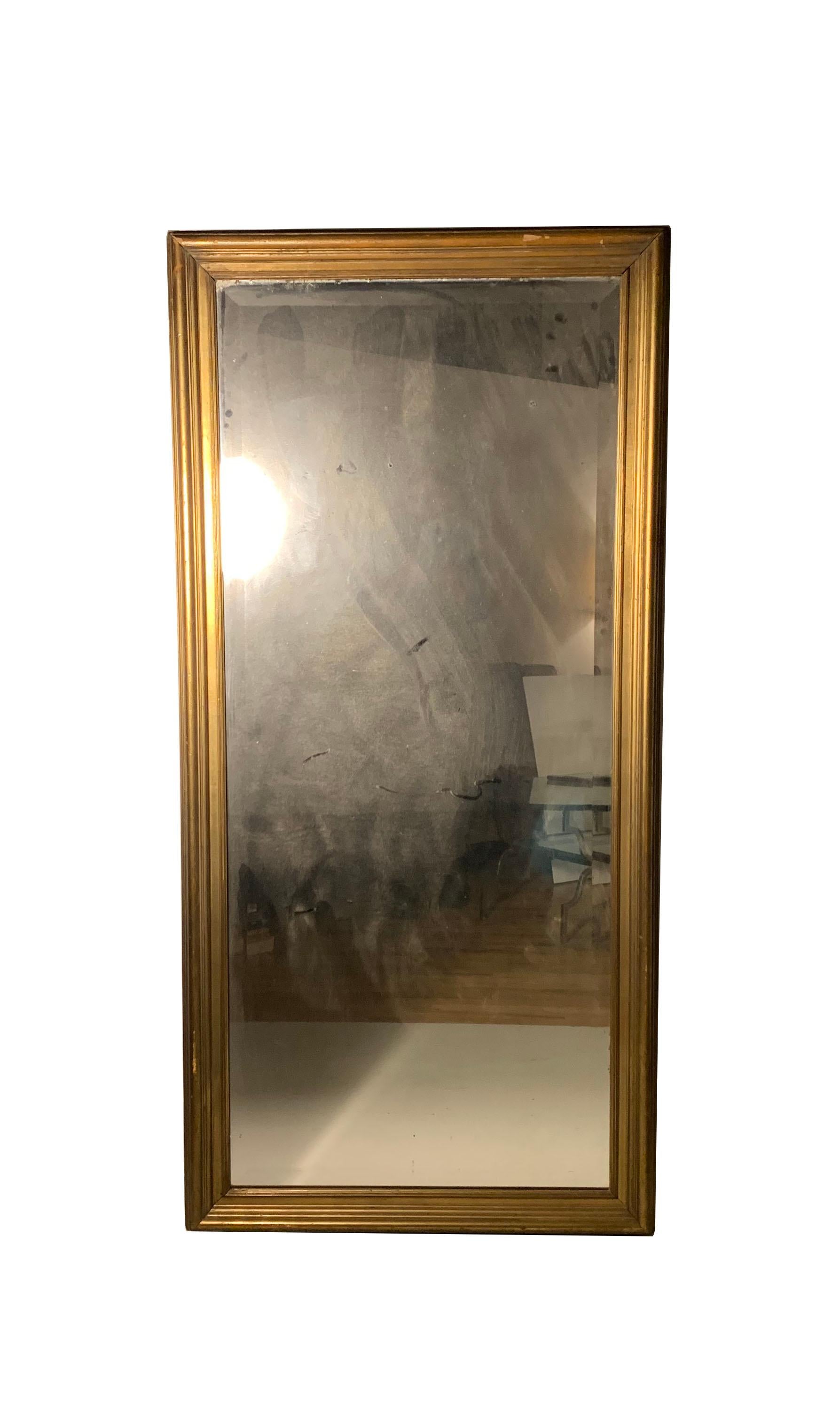Large Gilt Antique Frame or Mirror.

As found. Appears to be of good age. Early 20th century. A Gilding overall.  

Mirror shows signs of age as does the wood frame. Gray pieces on back were added later for stability it appears. 