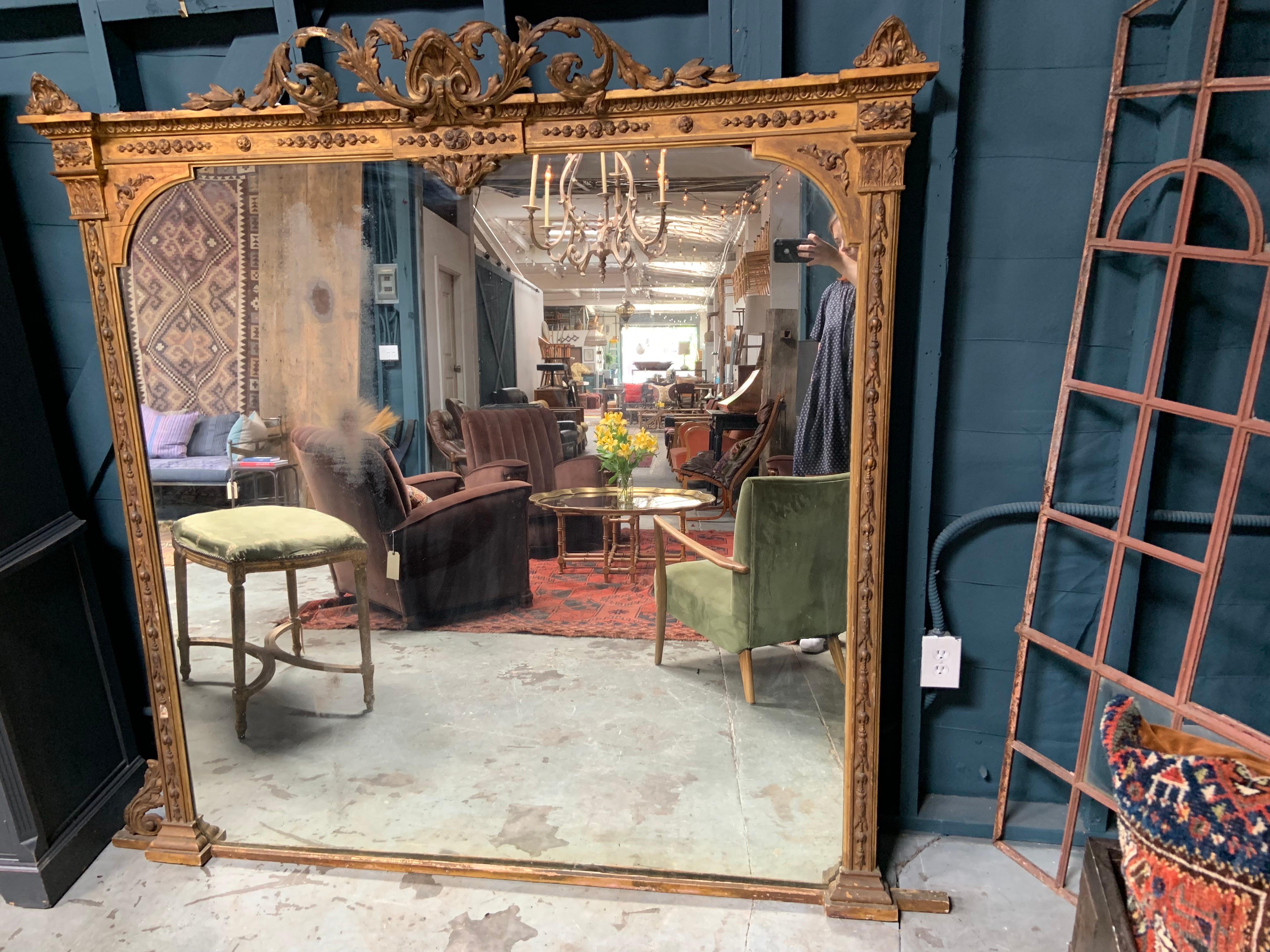 19th century Baroque Style gilt mirror dating to around the 1860s. This mirror could use a little restoration mainly along the frame. The glass has some wear, but also looks incredible as is, the imperfections add so much character to this gorgeous