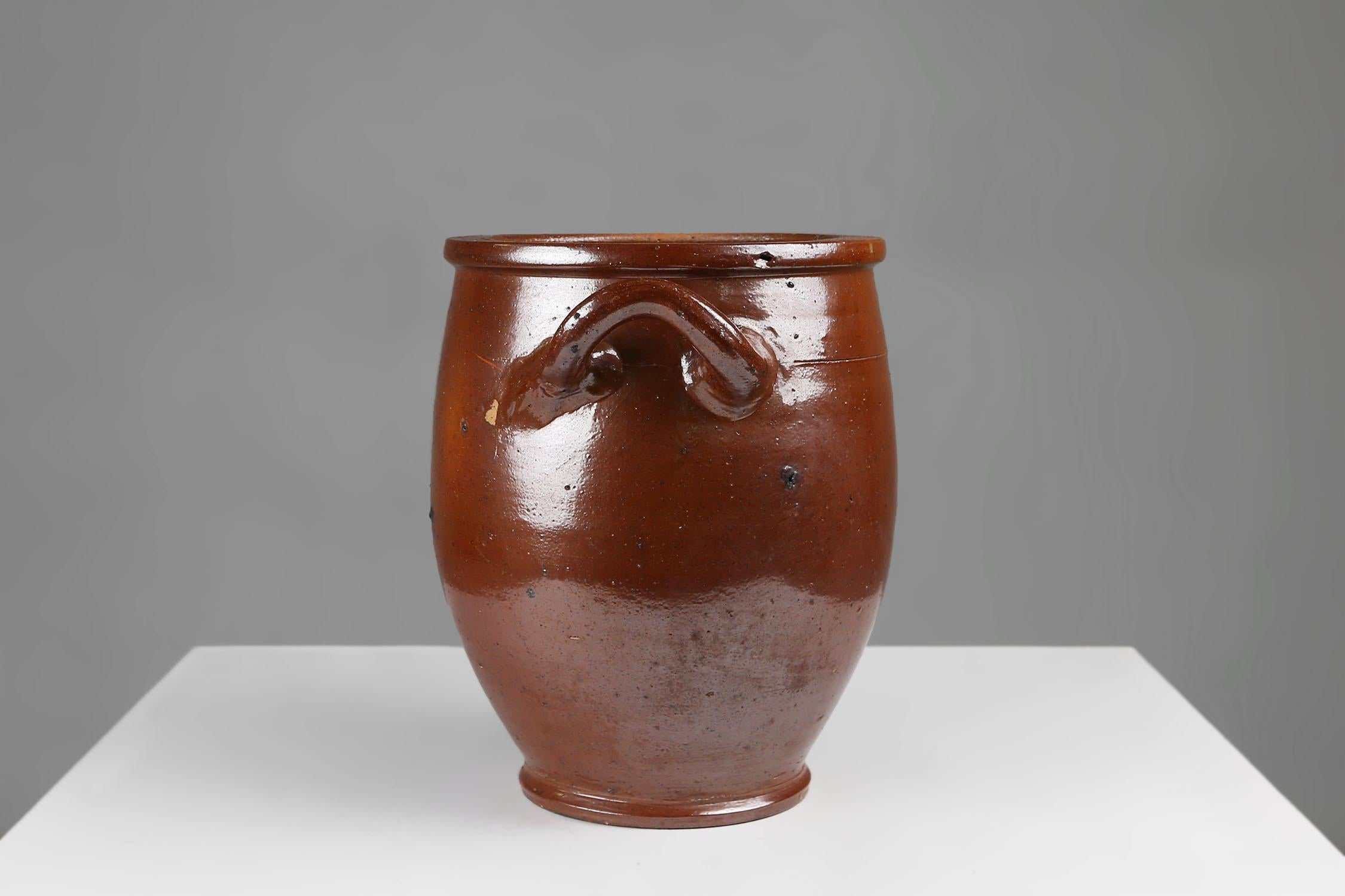 Belgium / 1800s / antique / ceramics / pot / brown glazed   A Belgian Ceramic Pot from the 1800s, a timeless piece that combines elegance and functionality. This large brown pot with handles on the side is a must-have addition to any kitchen or