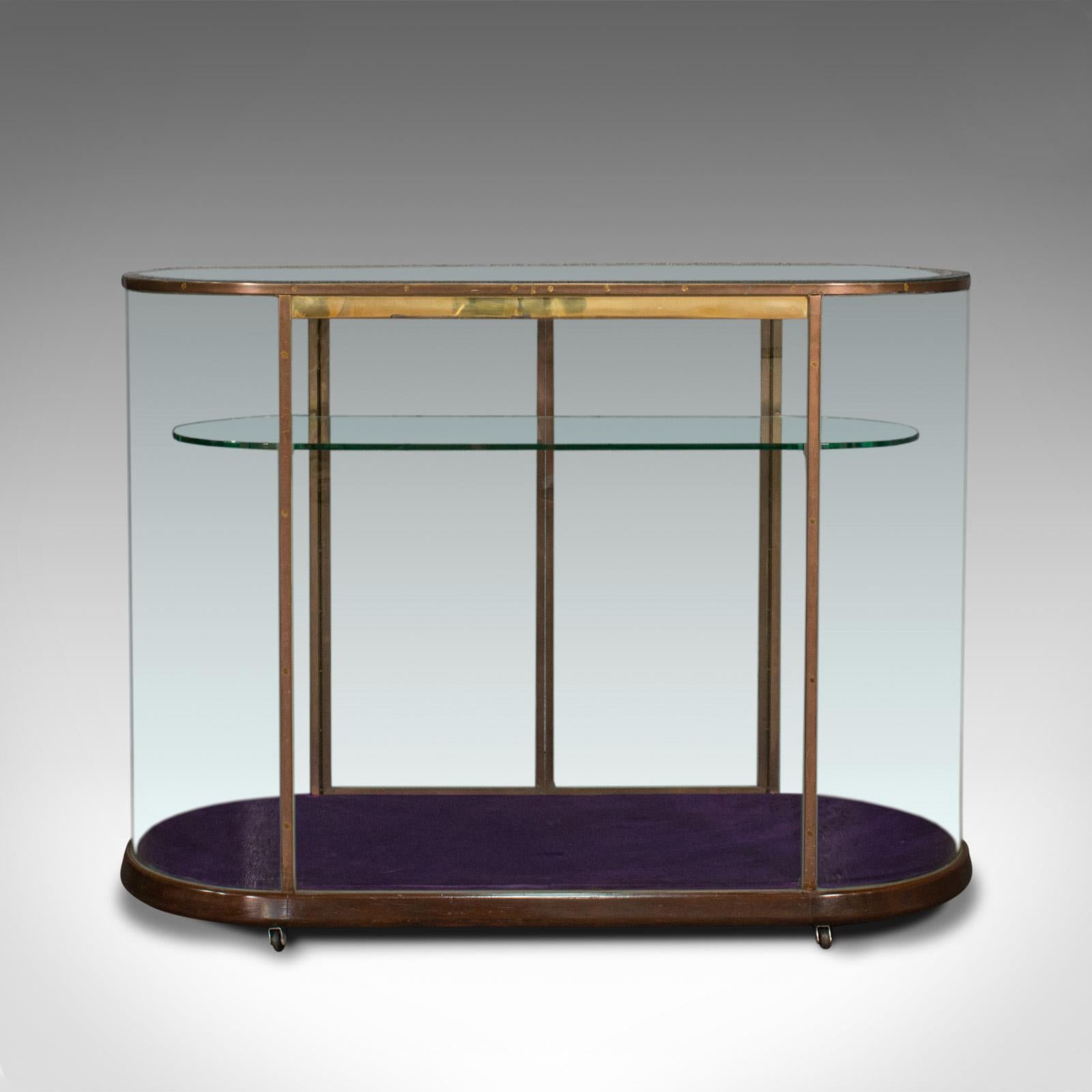 This is a large antique glazed display cabinet. An English, bronze shop retail showcase, dating to the Edwardian period, circa 1910.

Bright, open framed showcase with assured Edwardian elegance
Displaying a desirable aged patina - wear to top