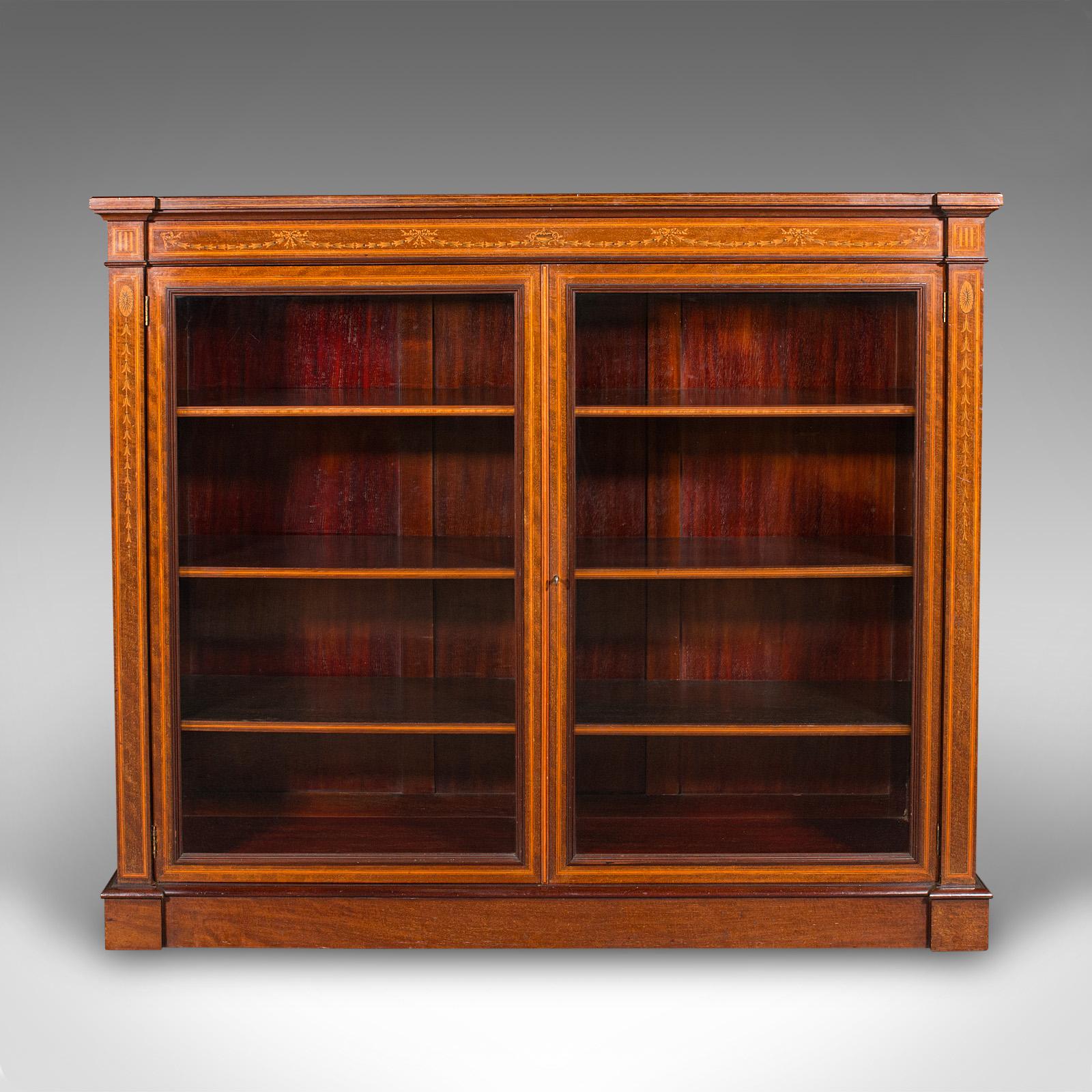 This is a large antique glazed display cabinet. An English, walnut and boxwood drawing room bookcase, dating to the Edwardian period, circa 1910.

Exceptional example, with superb colour and marquetry detail
Displays a desirable aged patina and in