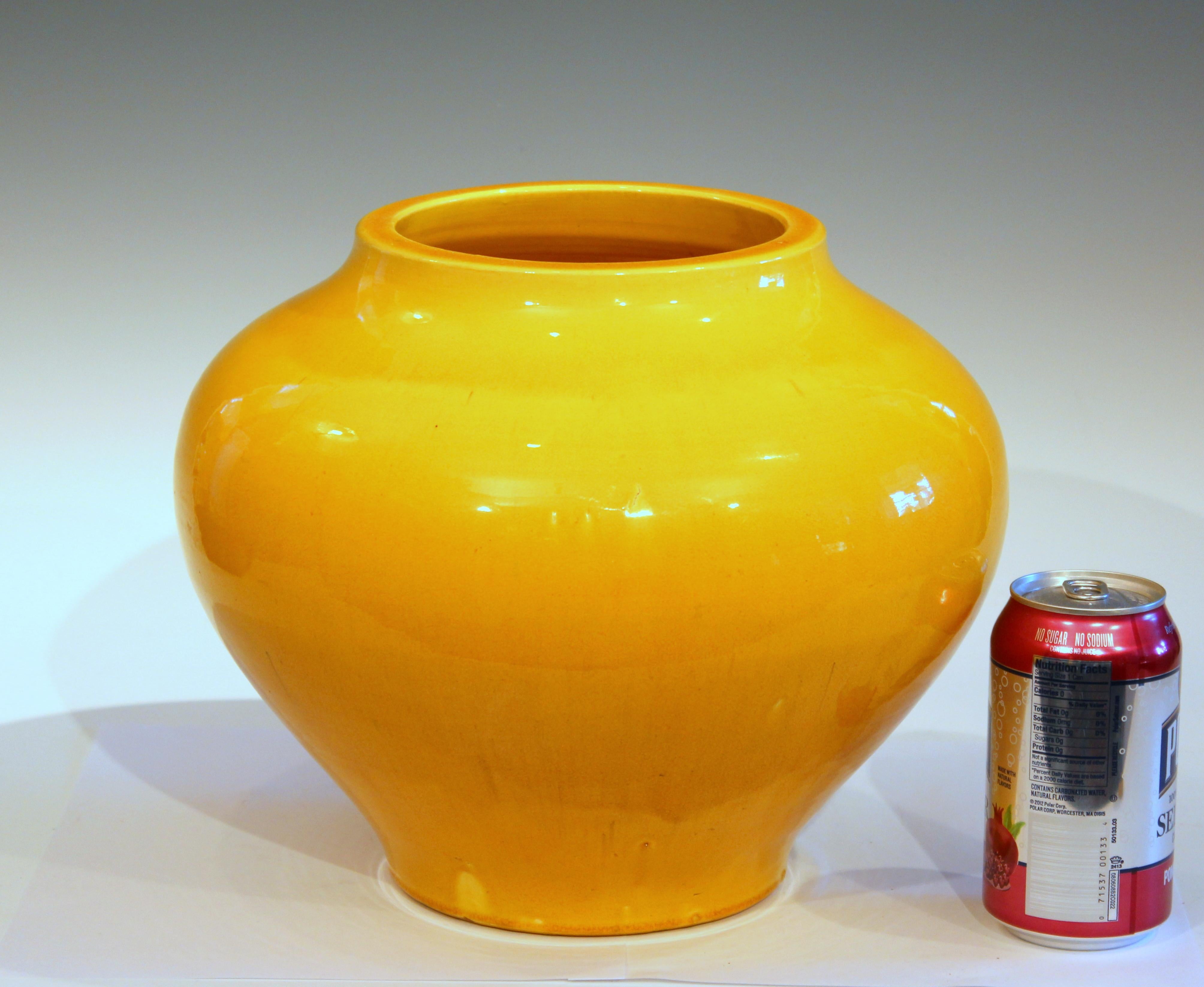 Big Awaji pot in compressed Hu form with soothing, warm, yellow glaze, circa 1910s. Impressed marks. Measures: 9 1/2