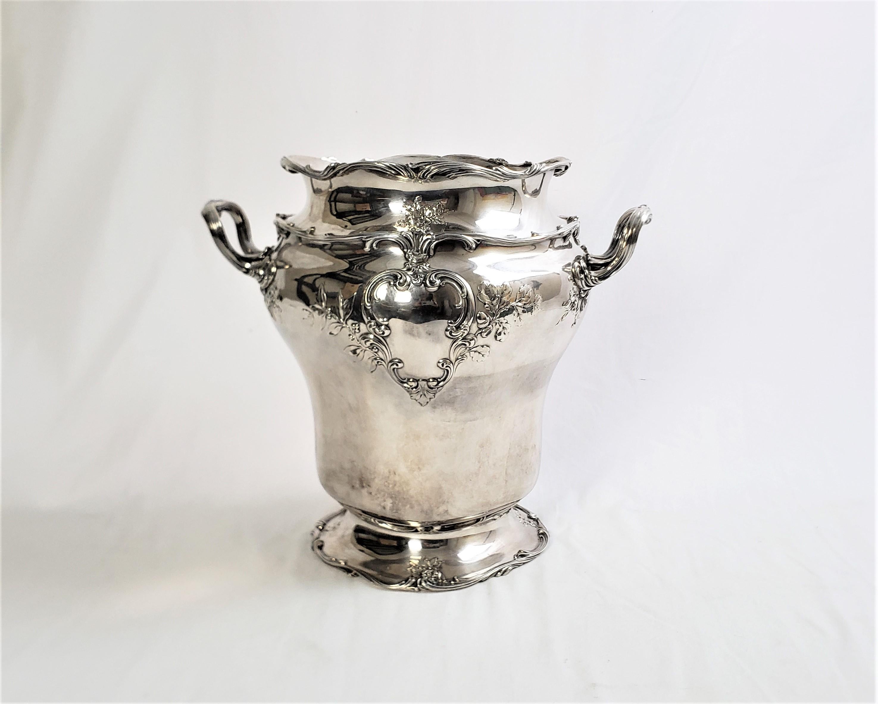This large and substantial chanpagne bucket or wine chiller was made by the renowned Gorham Co. of the United States in approximately 1900 in a Victorian style. The champagne bucket is composed of sterling silver and decorated with applied stylized