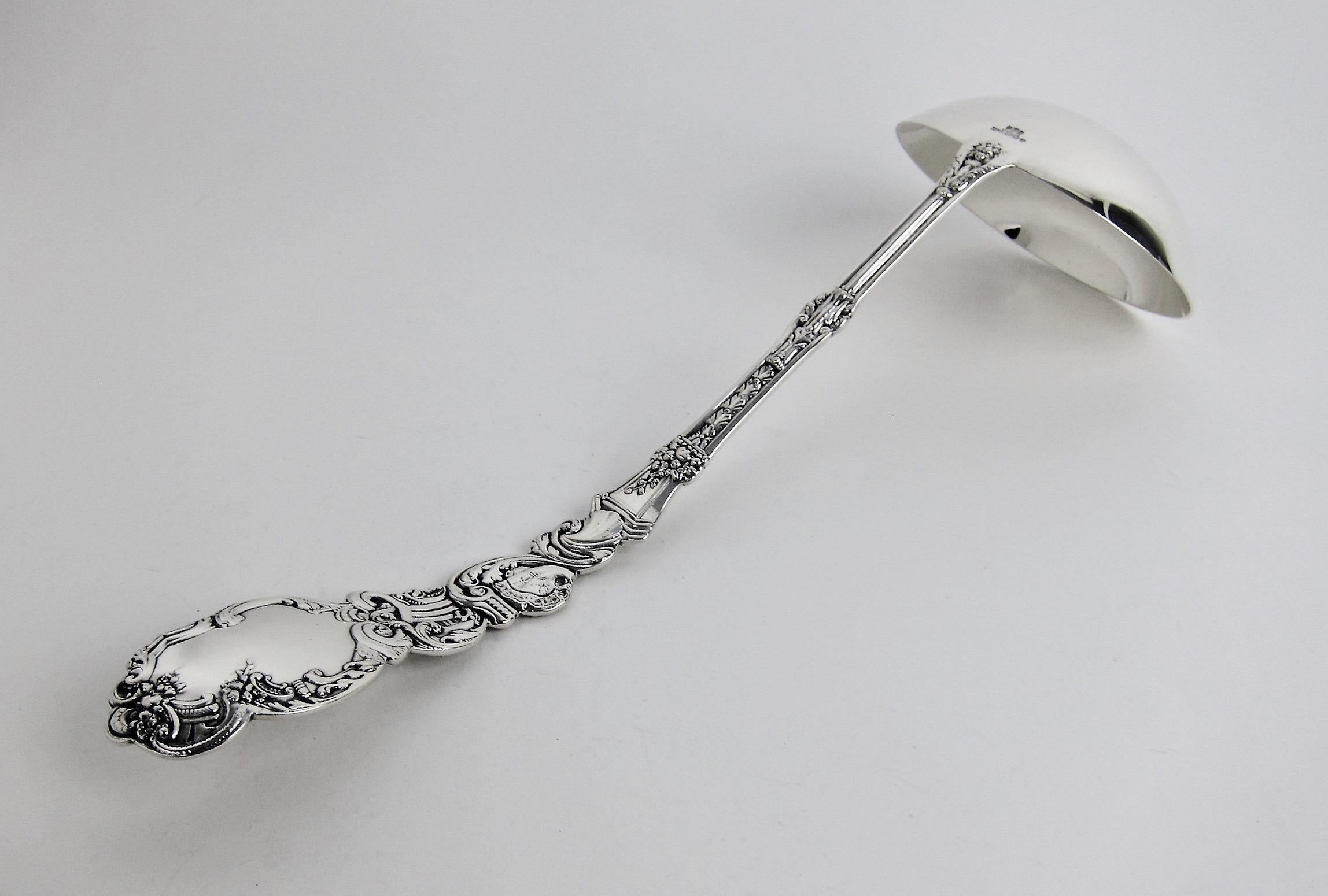 A large antique soup ladle in solid sterling silver from Gorham Manufacturing Company of Providence, Rhode Island dating circa 1890. The heavily ornamented ladle is part of Gorham's elaborate Versailles pattern, designed in the Beaux Arts style by