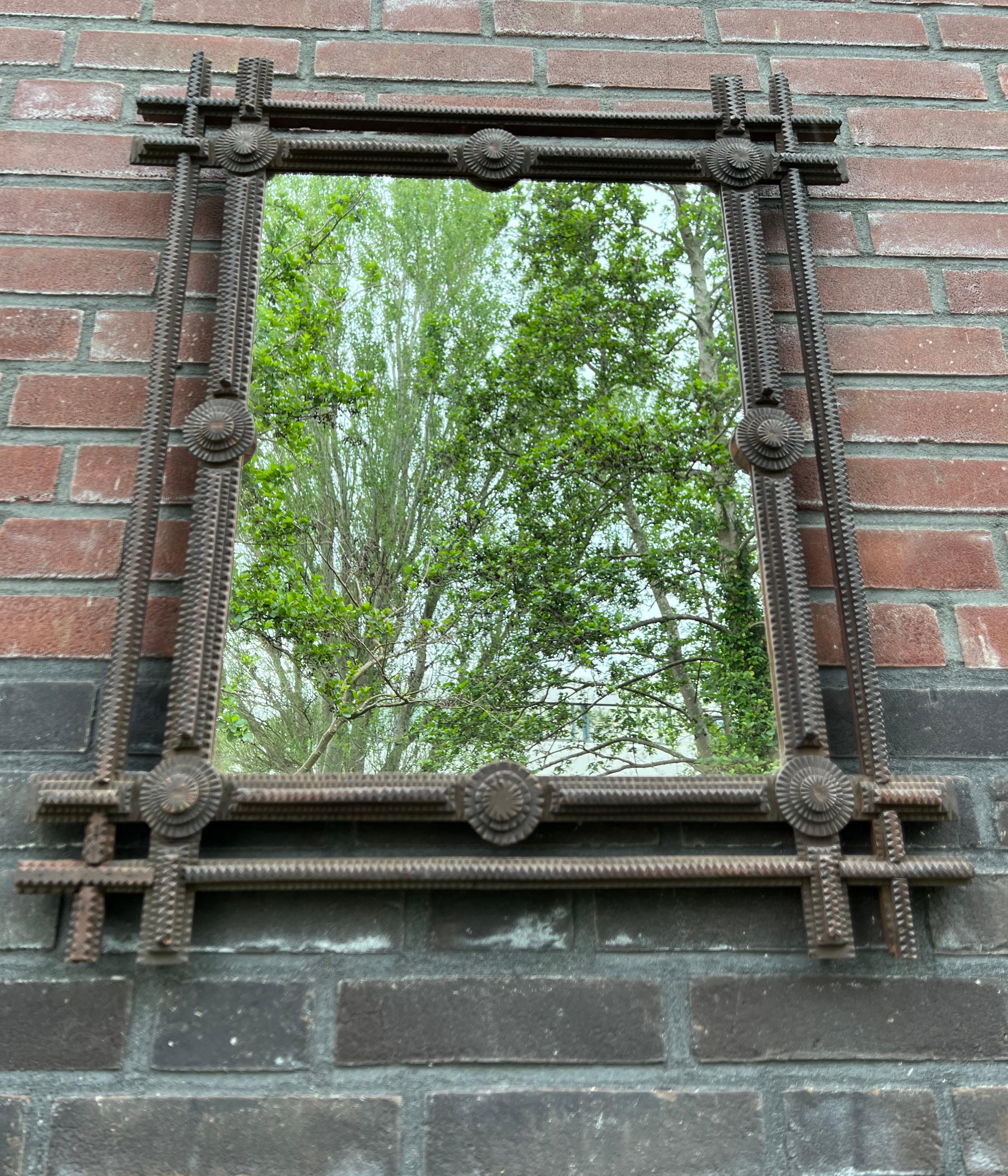 Beautifully hand crafted antique folk art frame with glass mirror. 

For the collectors of top quality and sizable antiques in general and Tramp Art home accessories in particular we also have this stunning and one of a kind mirror with a Gothic