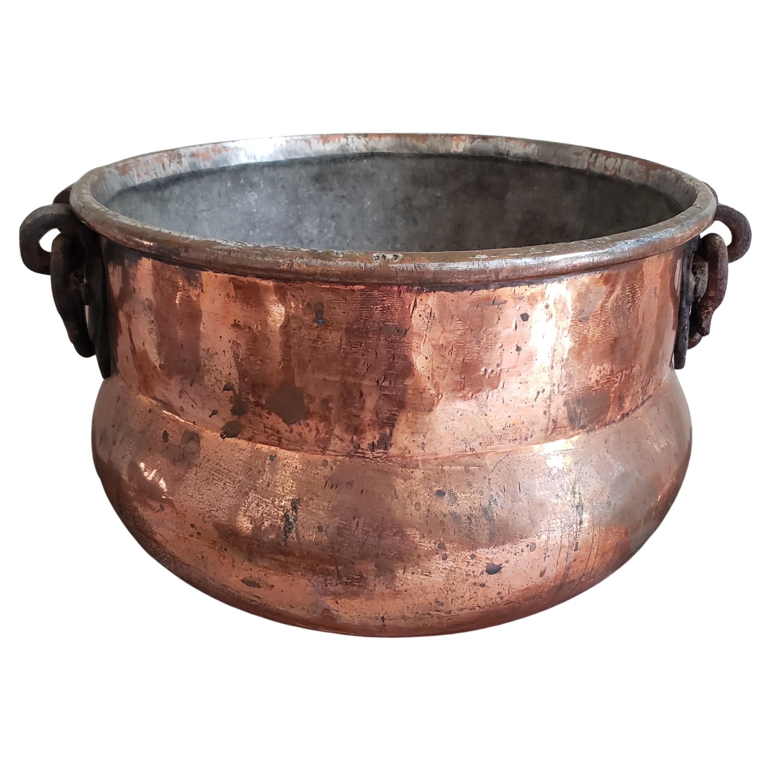 A large, heavy duty hand hammered jardiniere, planter in solid copper with iron drop down handles. Very good antique condition.
Measures 19