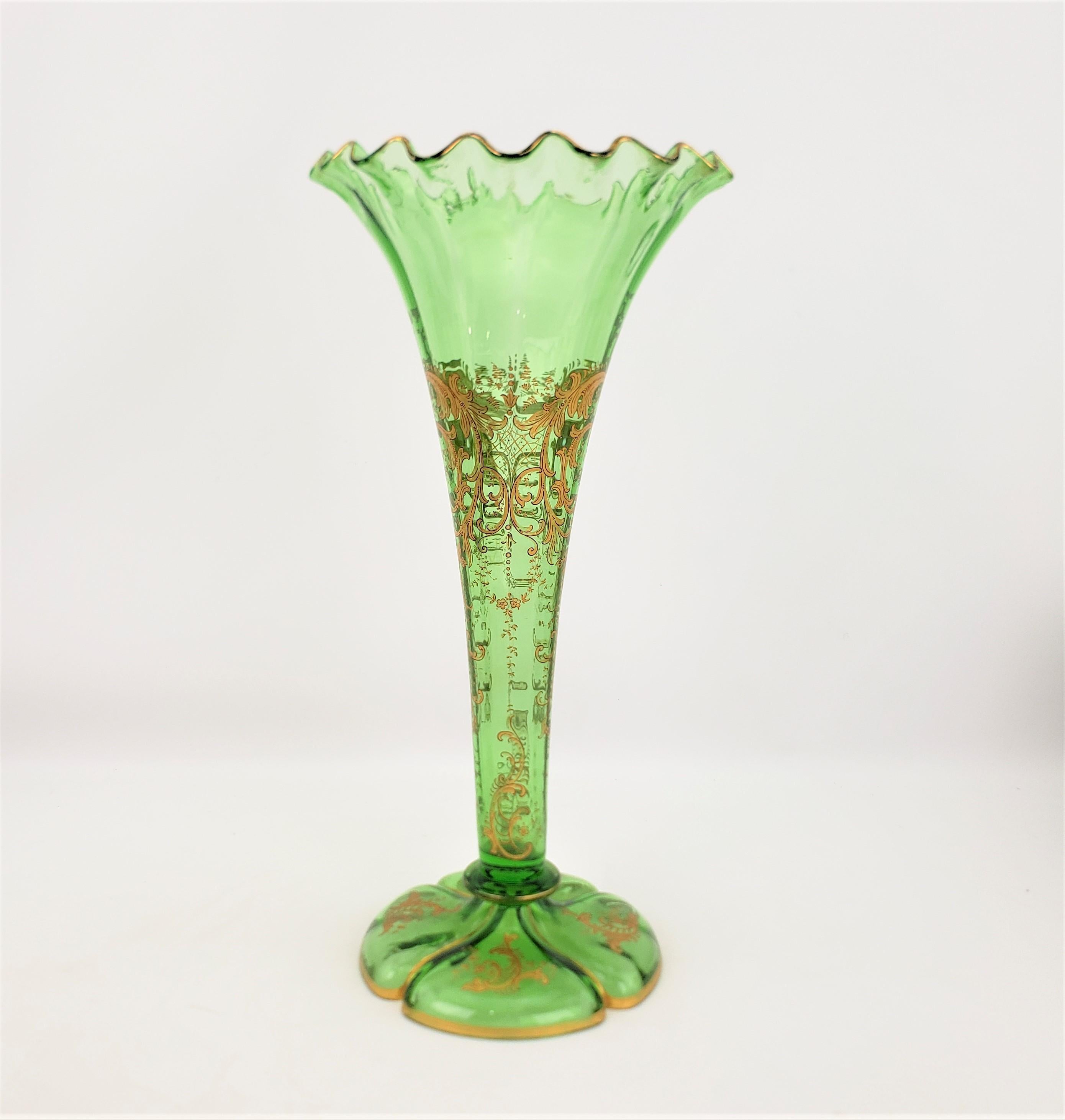 This large green antique art glass trumpet vase is unsigned, but presumed to have originated from England and dating to approximately 1880 and done in the period Victorian style. The vase has a trumpet shape with fluted edges around the top and a