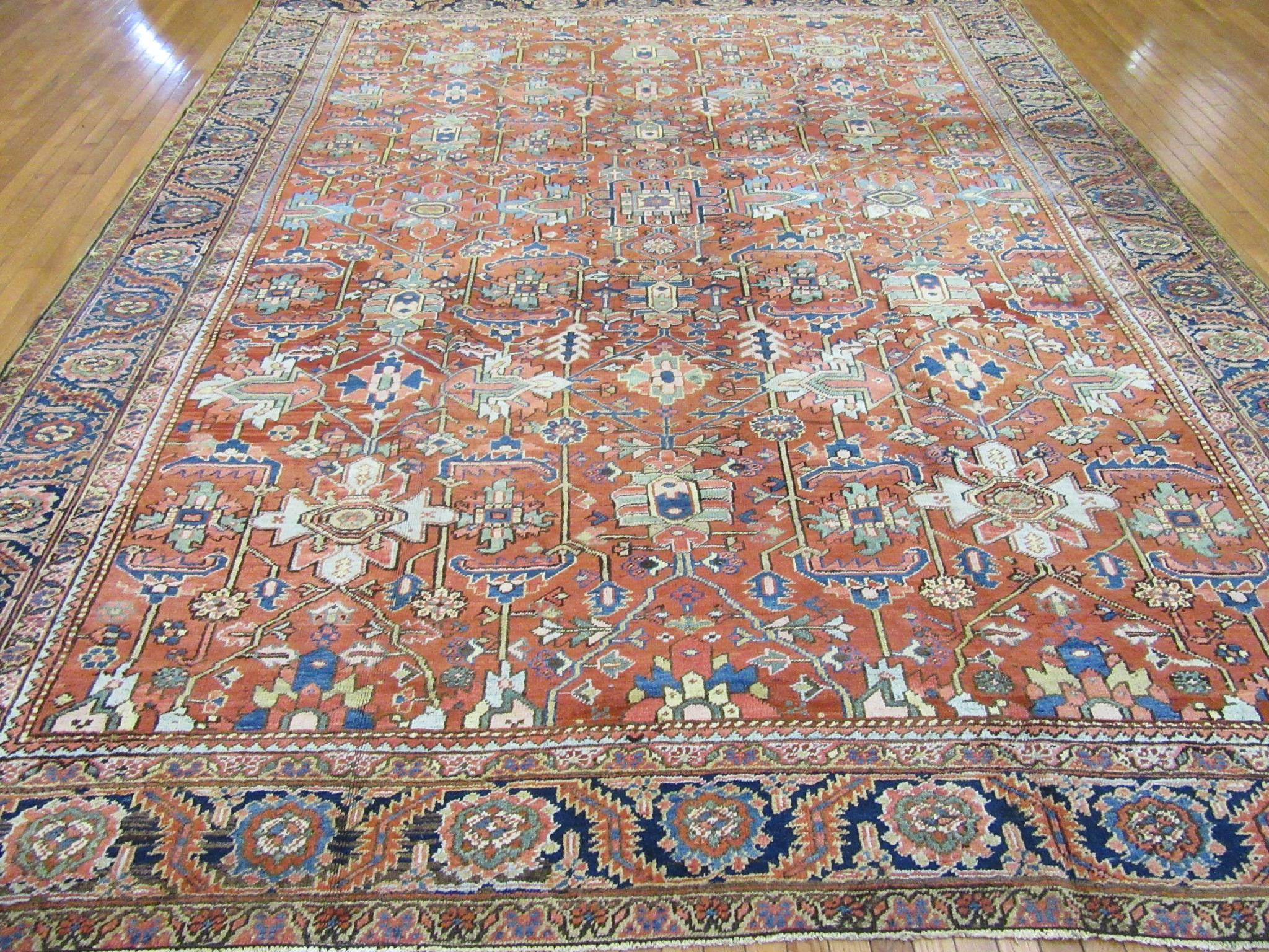 This is an antique hand-knotted rug from the village of Heriz in northwest Iran (Persian). It is made with wool colored with natural dyes on a cotton foundation. It 's none conventional all-over pattern makes it an easy rug to work with. The rug is