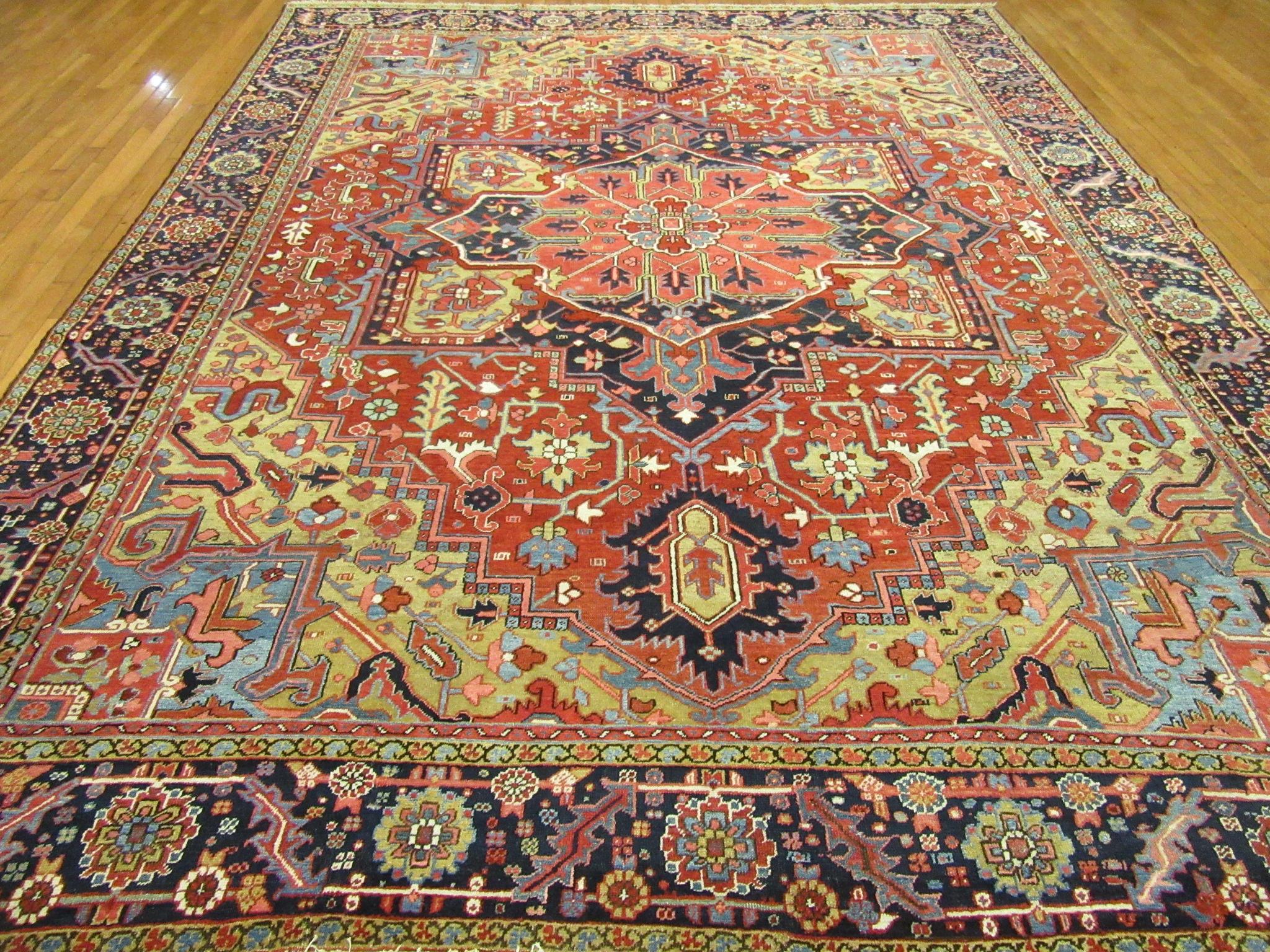 This is antique hand knotted Persian rug from the infamous village of Heriz in northwest Iran. It is made with wool colored with all natural dyes on a cotton foundation in the classic central and corner medallion Heriz design proven to be one of the