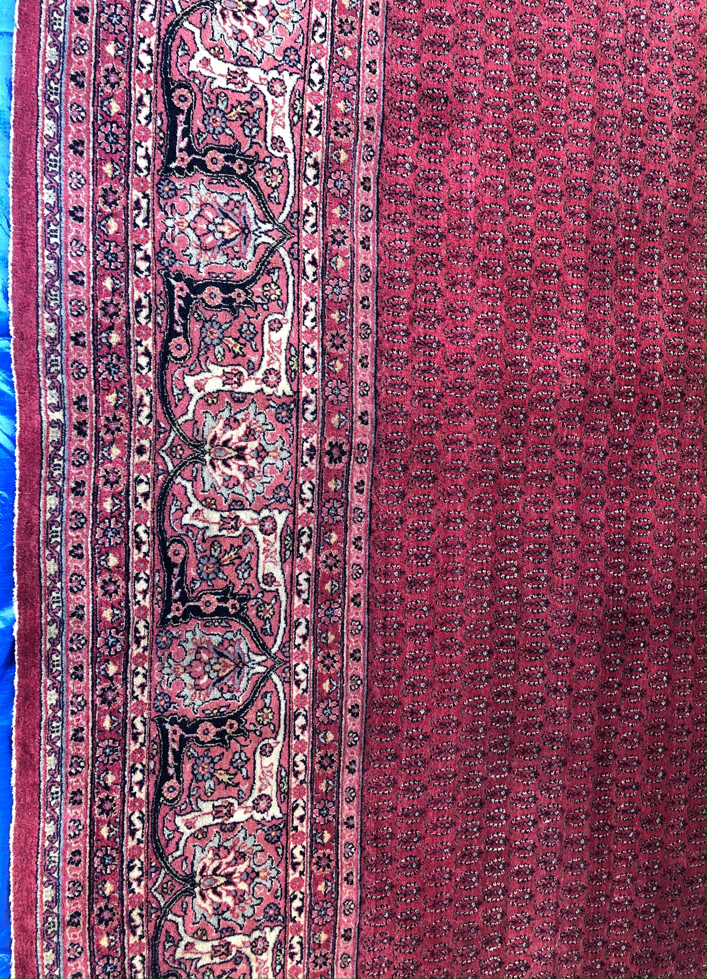 Beautiful decorative rug hand-knotted in the province of northern Kurdistan. The pattern consists of rhombs, mir-e buteh and herati and the carpet is dominated by burgundy and beige colors. The wool is generally of high quality similarly found in