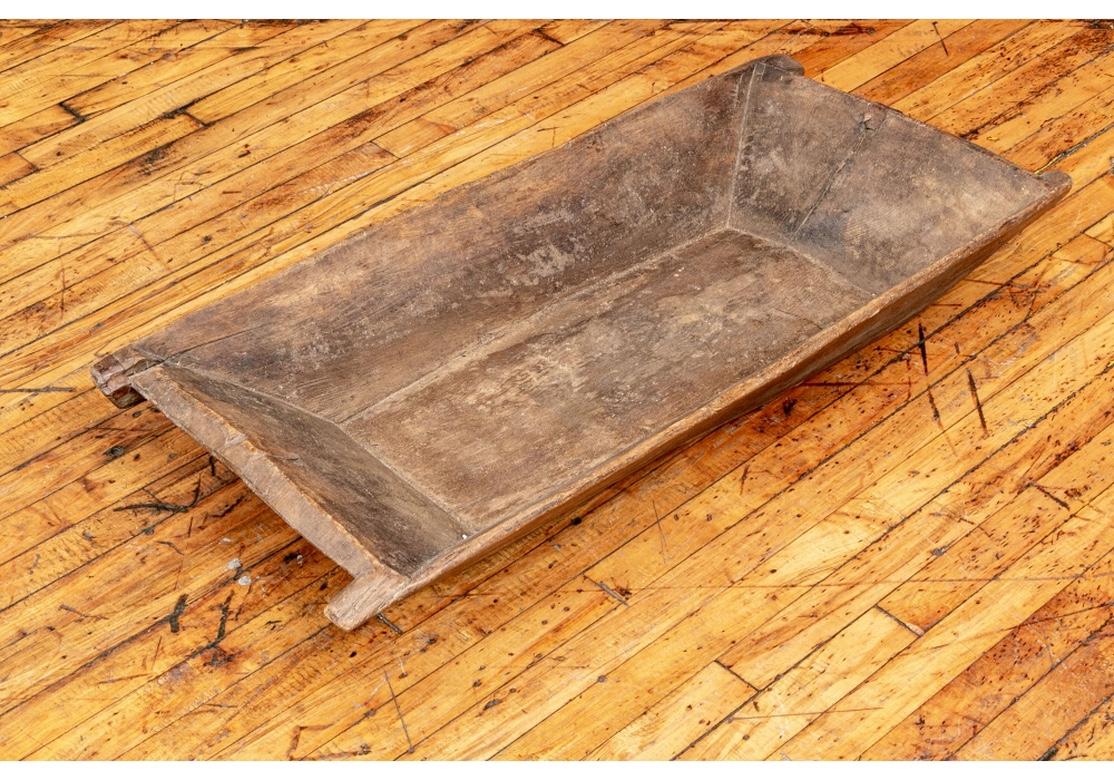 A large hand carved antique dough trough form bowl in Very good all original condition. A deep rectangular bowl with extended ends on the short sides. Great age and use patina.
Measures: L. 40 1/2