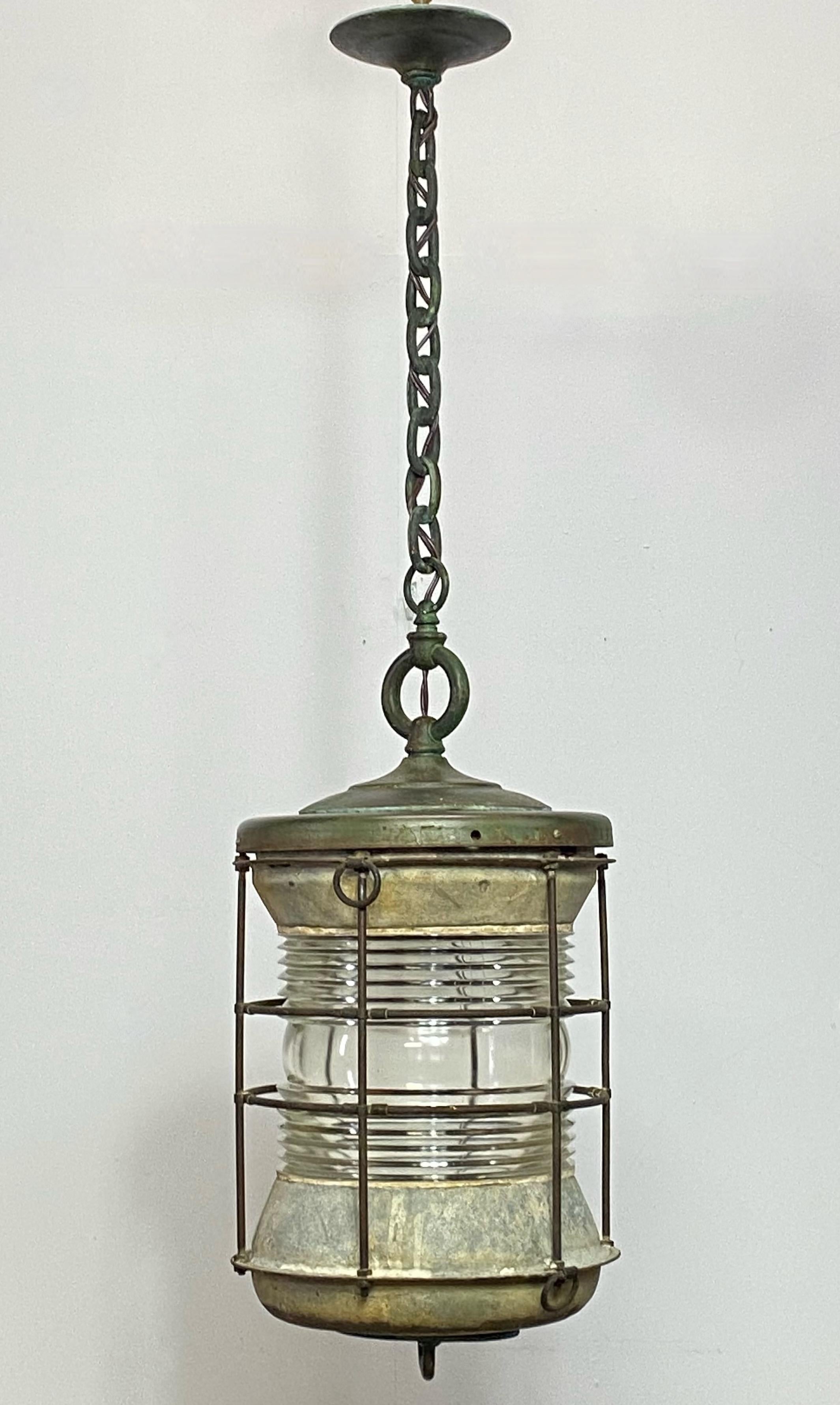A large antique brass, glass, tin and steel ships' lantern with antique bronze chain.
Recently re-wired and ready to install. We can shorten the chain to clients specifications.
American, early 20th century.