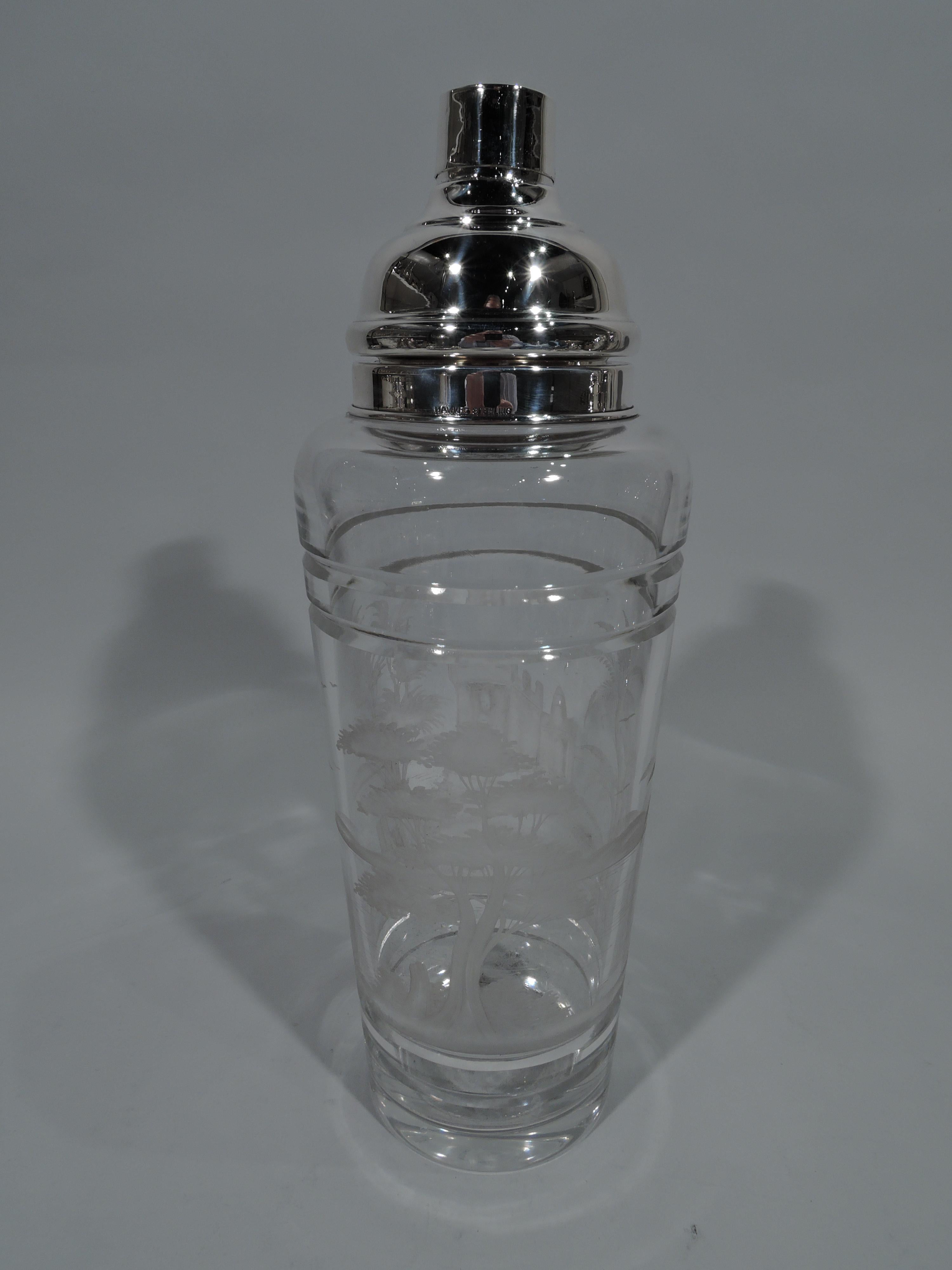 Large sterling silver and glass cocktail Shaker. Made by TG Hawkes & Co. in Corning, New York, circa 1920. Tapering glass cup with cut bands and acid-etched landscape depicting rippling water, trees, and castle. Short neck with sterling silver