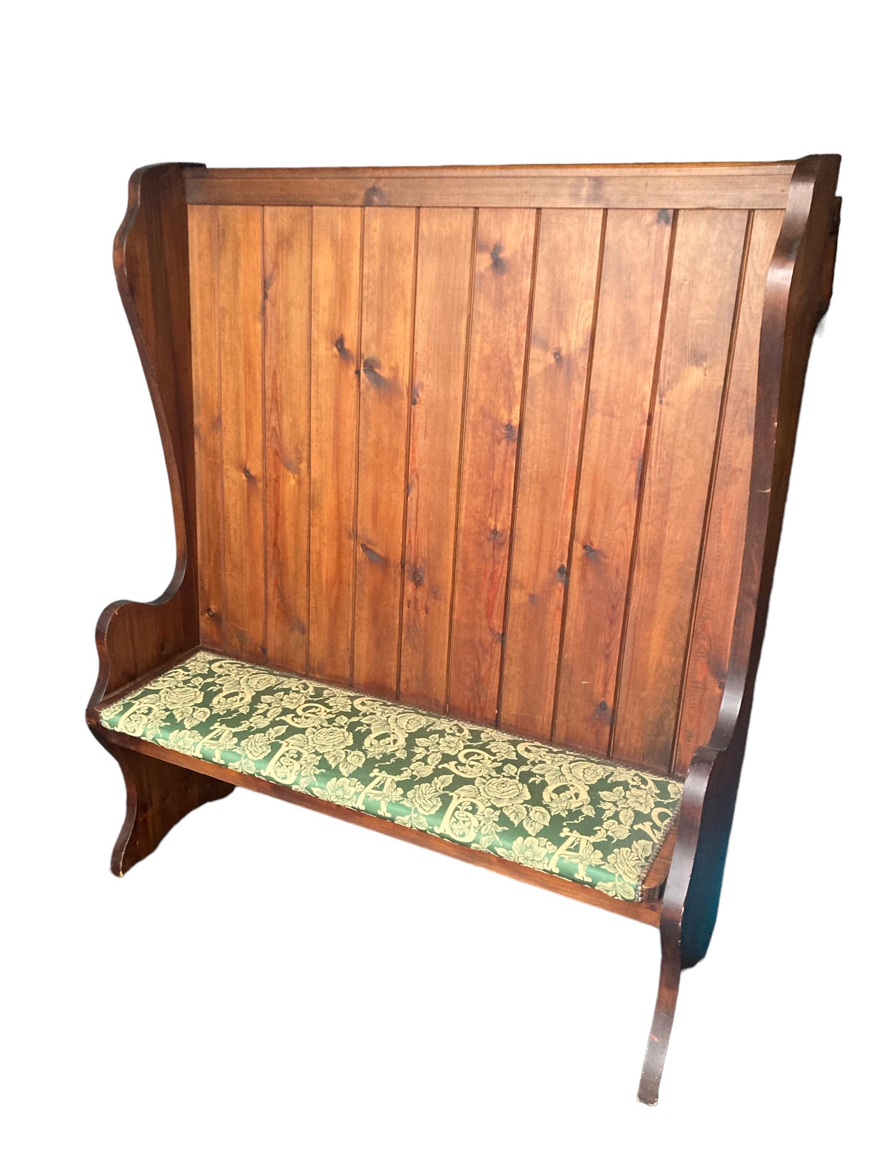 Large High Back Pine Church Pew CIRCA 1920'S. Sating green upholstery decorating with letters and floral design. Crafted with precision and attention to detail, this timeless piece effortlessly combines elegance and functionality. The sturdy pine