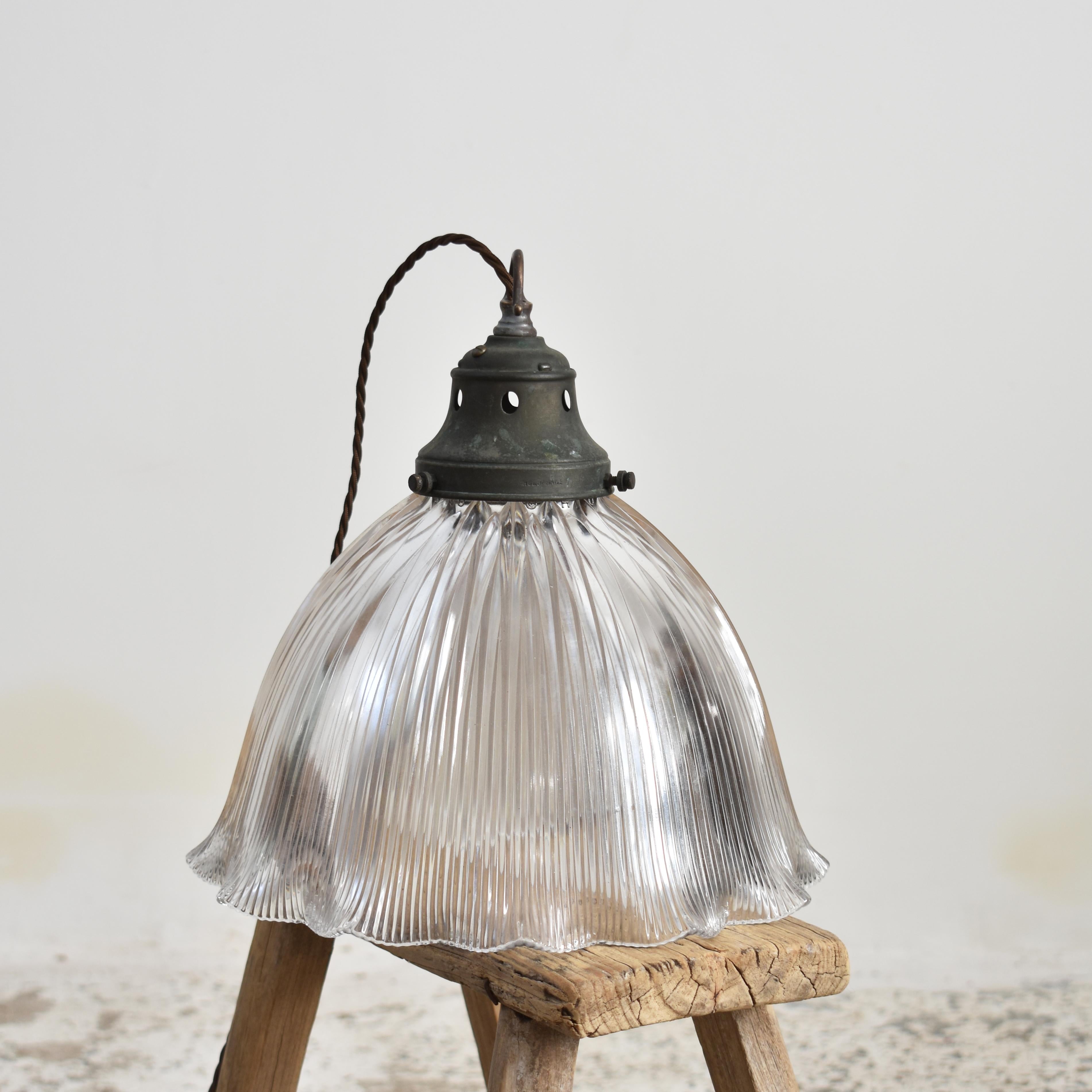 Large Antique Glass Holophane Frill Pendant Light – L

A rare large antique frill glass prismatic pendant light shade which looks great both lit and unlit. The light has retained its original brass gallery, which has some great age and painta