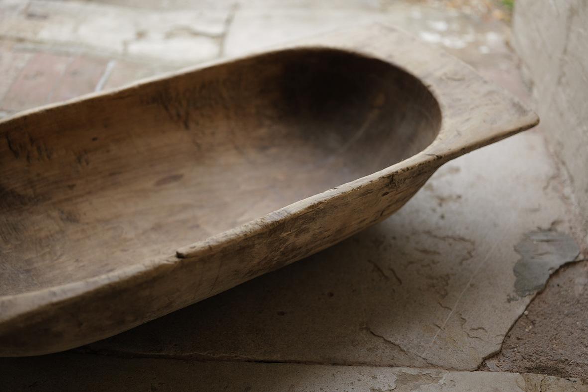 This large antique Hungarian dough bowl, is a striking example of early 20th-century rural craftsmanship. Hand-carved from solid wood around the early 1900s, the bowl measures just under one metre in length and was originally used for kneading and