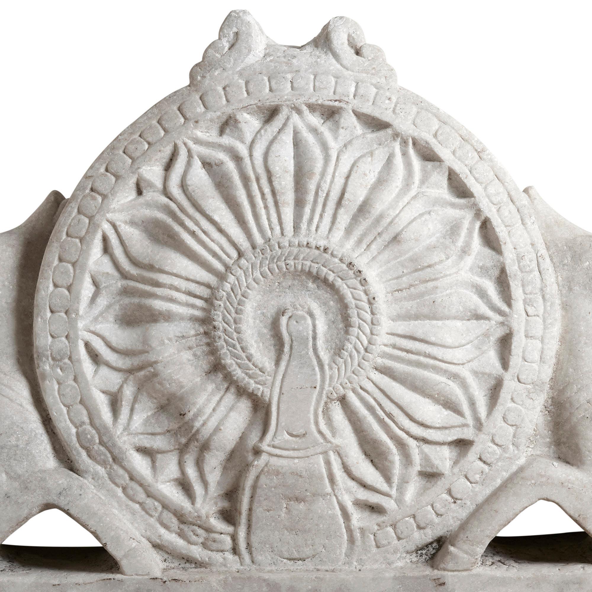 Large antique Indian carved marble lintel
Indian, 18th century
Measures: Height 83cm, width 170cm, depth 22cm

Finely carved in white marble, this sculpture is a wonderful example of Indian Buddhist sculpture. It portrays a Dharma wheel with two