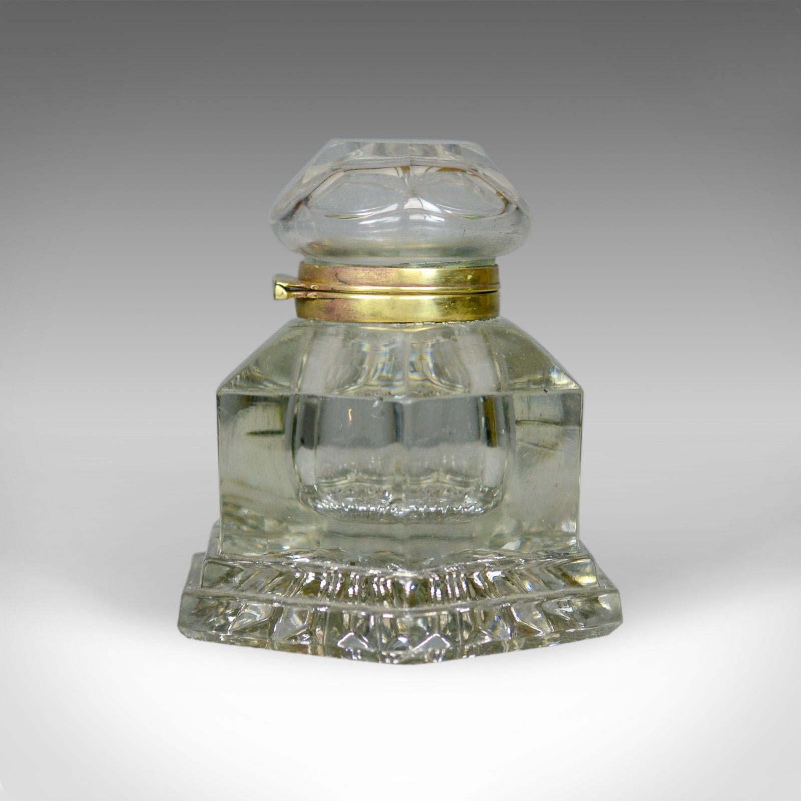 This is a large antique ink well. An English, crystal glass, desk ink well dating to the mid-19th century, circa 1850.

Larger than most at 13 cm, 5 inches high
Hexagonal in form with floral base pattern
Hinged lid opens smoothly
Canted