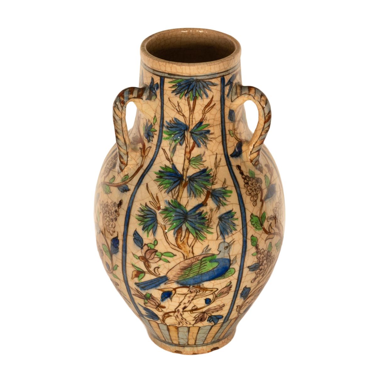 A large antique 19th Century Persian/Ottoman Qajar period glazed three handled Iznik vase, circa 1850.
This very large hand thrown vase of baluster shape having three handles to the top, the body of the vase with a cream ground which is profusely