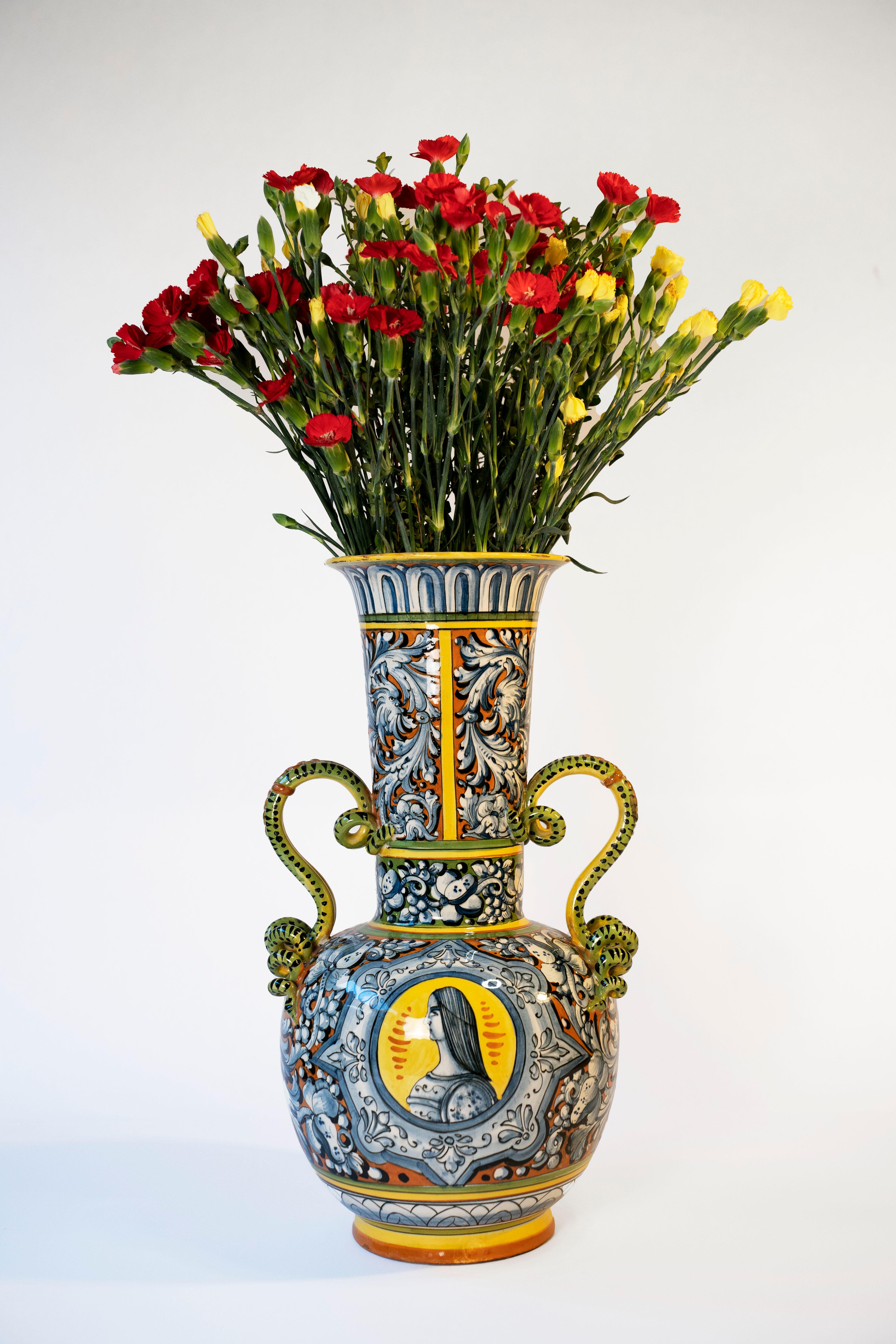 A Fine Large Antique Italian Majolica Urn, made in Italy.  Early 20th Century.  Globular vessel with tubular neck, coiled snake handles.  Hand painted with portrait medallions and scrolls.  Painting on this beautiful ceramic is amazing!  Would be a