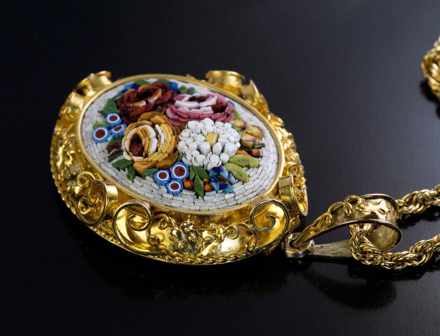 Italy, circa 1870

This antique Victorian 14K gold necklace features a large and very fine Roman micro mosaic floral bouquet. The micro mosaic plaque is set in an ornate gold frame with applied gold scrolls and grapevine leaves.

The back of the