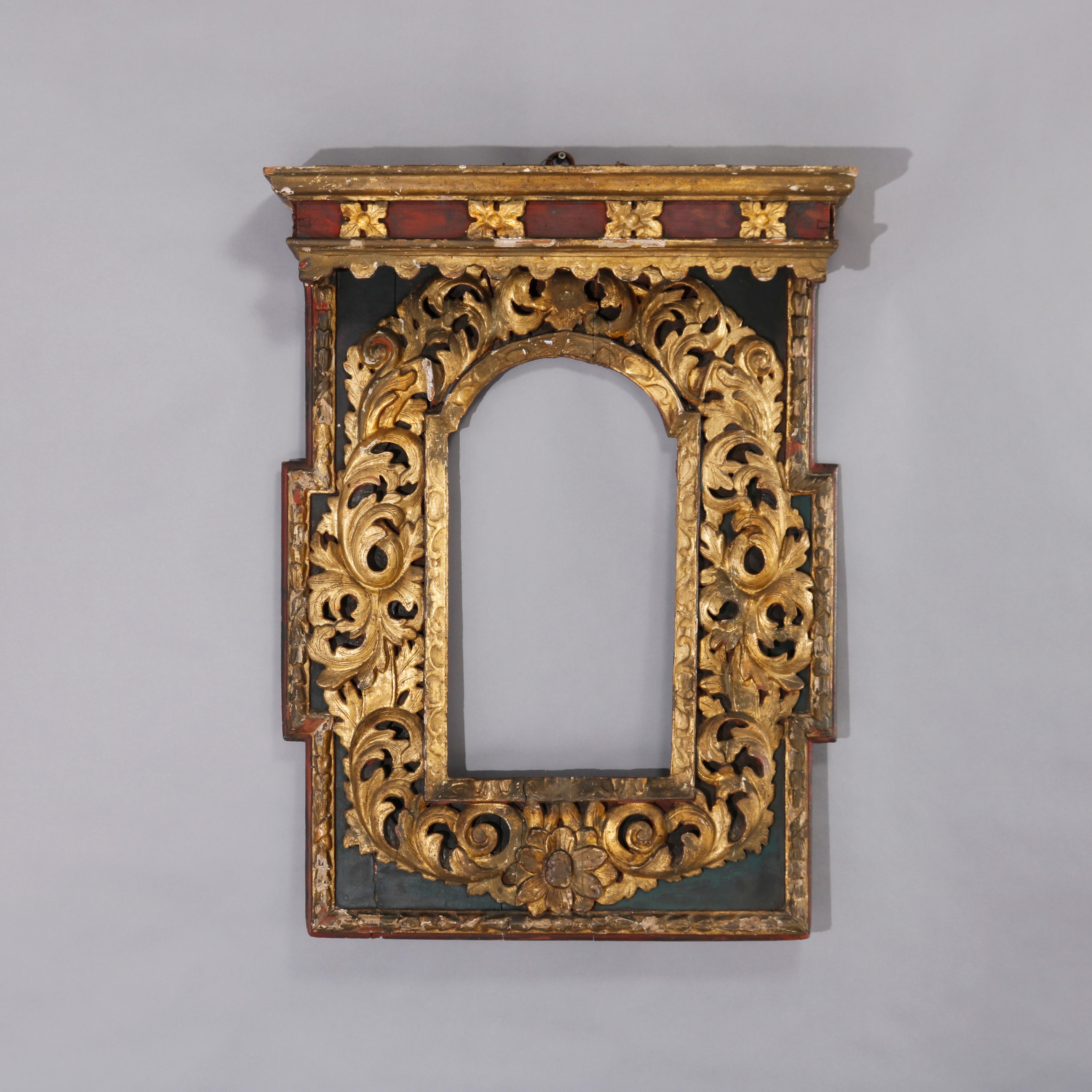 A large antique Italian Renaissance frame offers polychromed wood construction with gilt and deeply carved foliate, scroll and acanthus decoration, 17th or 18th century

Measures - 37.5''H x 27''W x 7''D.