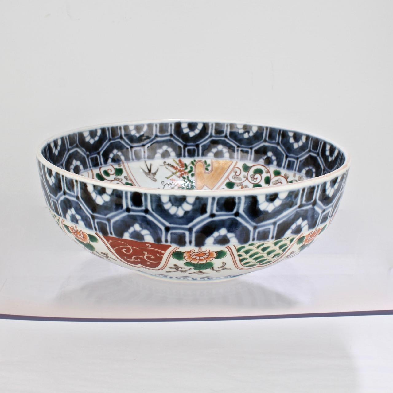 A fine, large antique Japanese Imari bowl.

Decorated with red, blue, green and ochre enamels throughout. 

Measures: Diameter: ca. 12 /12 in.





 