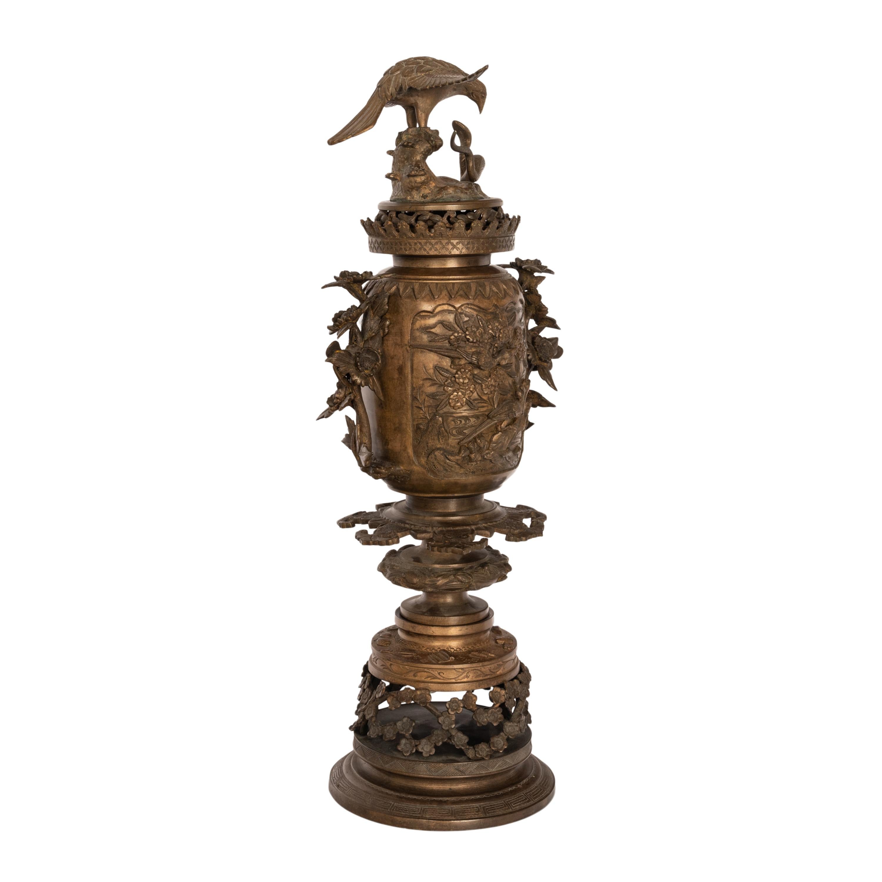 A fine & Large antique Japanese Meiji period bronze Koro or incense burner or urn, circa 1890.
Finely modeled with an eagle & snake to the top finial with a crown shaped cuff below, the bulbous body decorated in deep relief both front & rear with