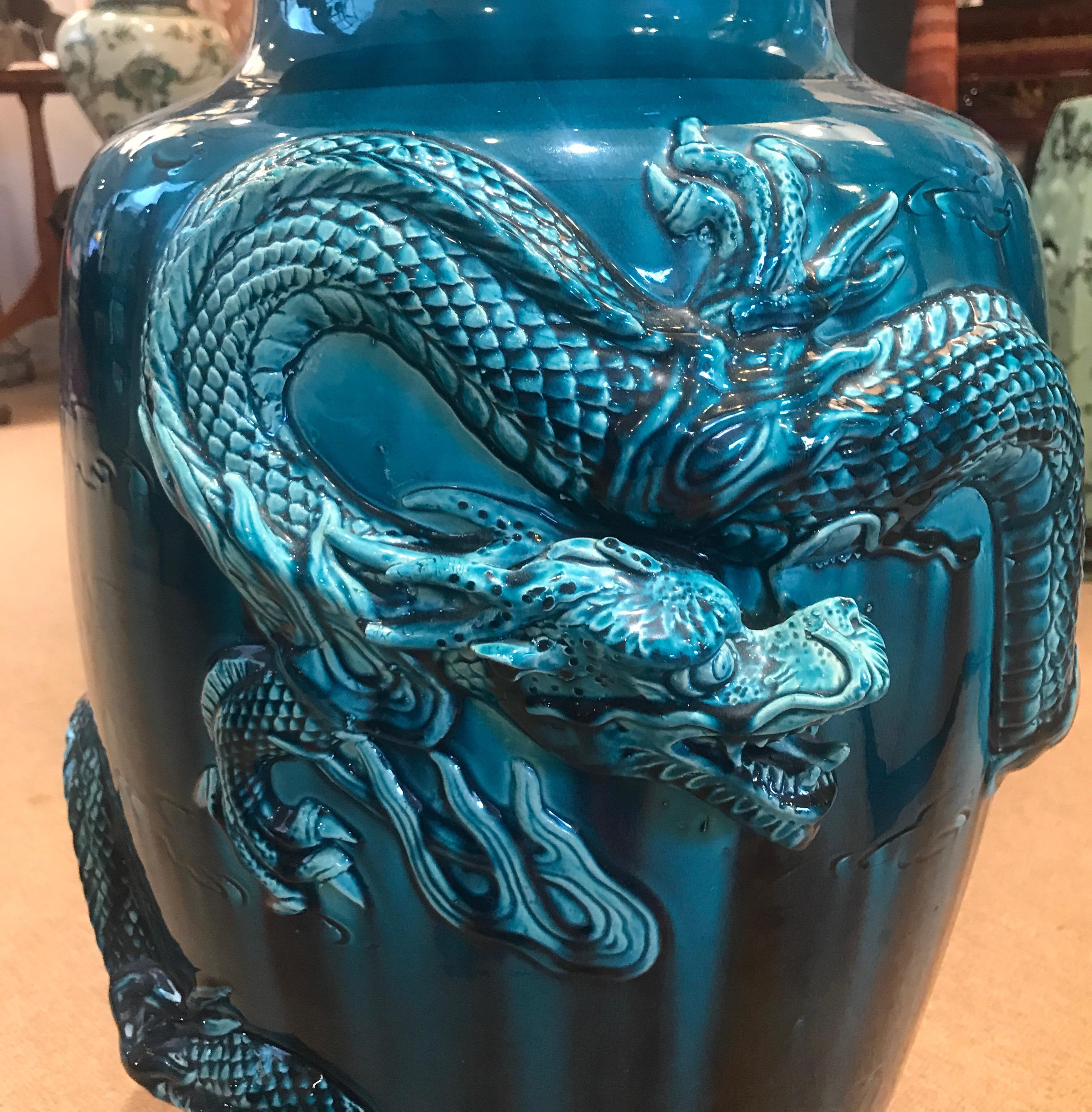 A teal flambe glazed Japanese vase with dragon motif. The early 20th century vase is from the Japanese arts and crafts period and is considered Awaji ware.
Awaji ware ( Awaji-yaki), also known as Minpei or Mimpei ware, is a type of Japanese pottery