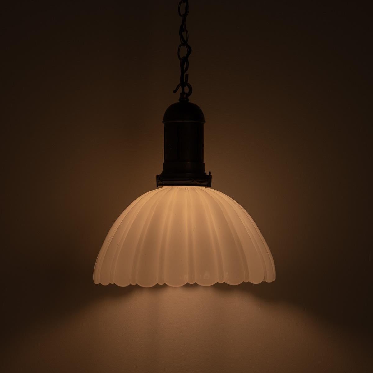 Antique Moonstone Pendant Light with Original Aged Brass Fittings

Rare oversized 12 inch diameter shades with elegant fluted design, tapered curve and scalloped edge to the thick quality moulded moonstone glass.

Original heavy cast brass gallery