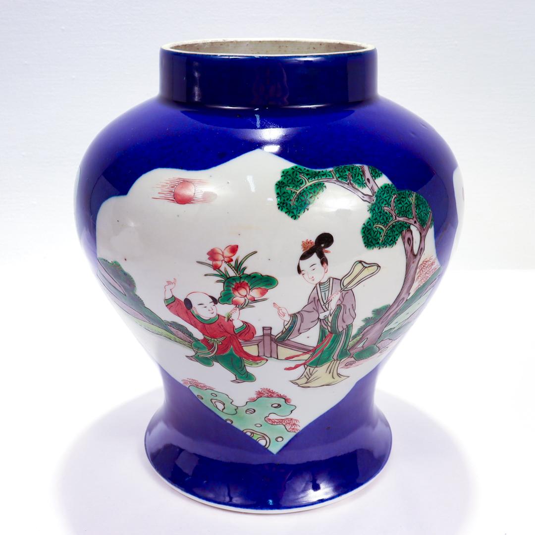 A fine antique Chinese porcelain vase.

In the Kang Xi style. 

With blue decoration on a white ground. 

Having ogee variant cartouches of landscape scenes of children playing outside with the white ground as negative space. Two of the cartouches