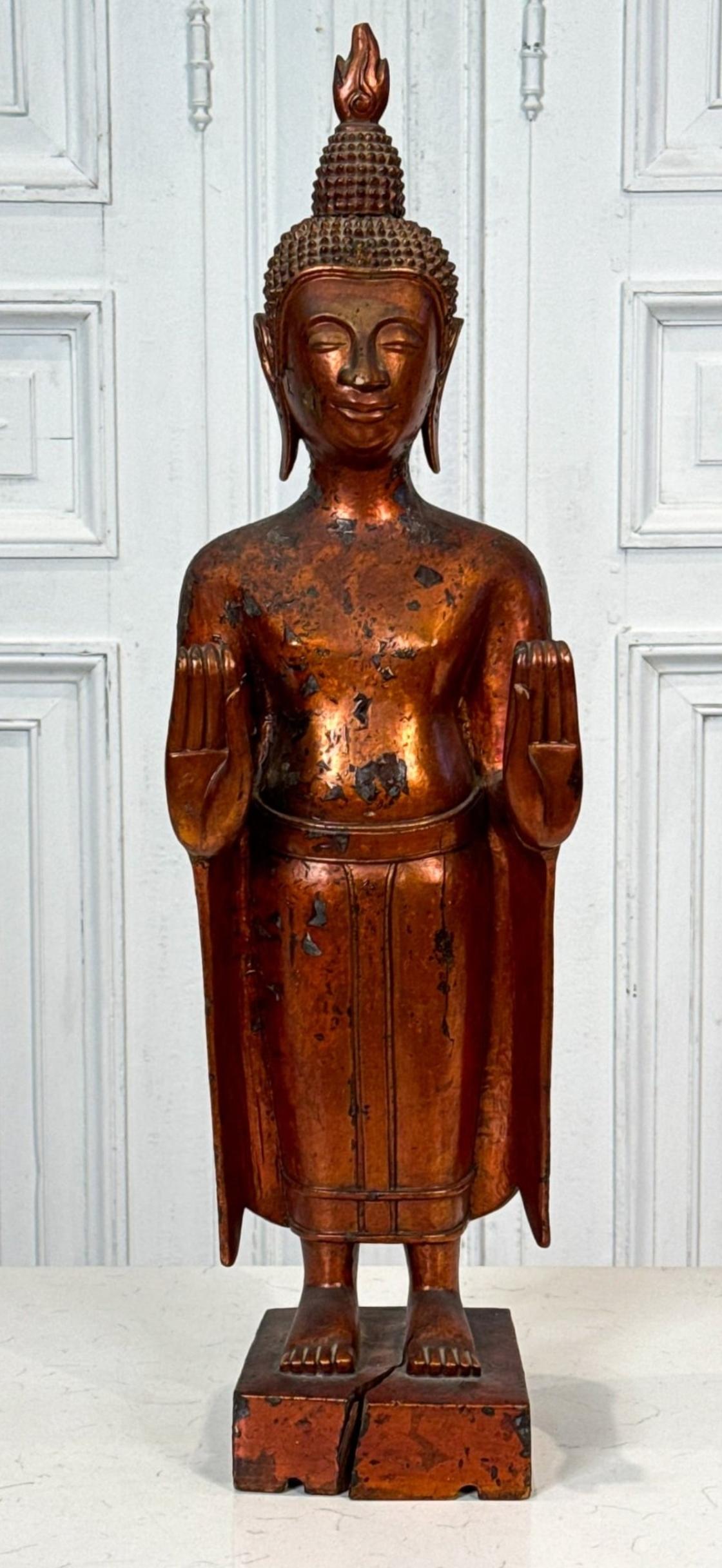 A beautiful antique Khmer hand carved wooden Buddhist figure.

Originating in Cambodia, Laos, Vietnam or Thailand, 19th century or earlier, the exceptional Southeast Asian antique religious sculpture depicting Buddha in standing pose with both hands