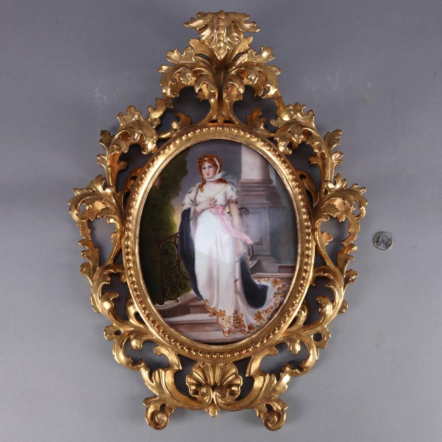 Large antique KPM School framed and hand-painted porcelain plaque features portrait of Prussian Queen Louise, seated in carved and pierced foliate and scroll giltwood frame, circa 1890.

Measures: 21_H x 15