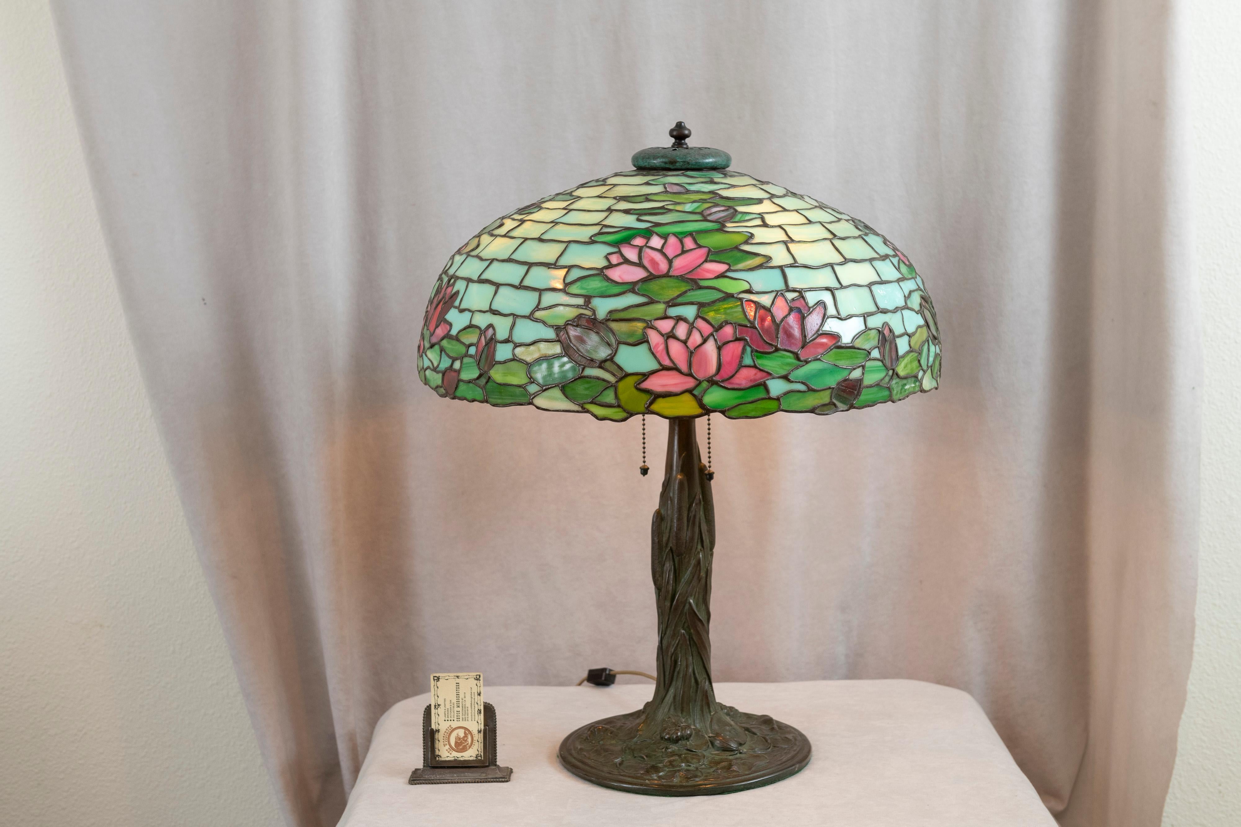 This very high quality leaded glass lamp was manufactured by the noted company Duffner & Kimberly. Those who get interested in leaded glass table lamps from the early 20th century will undoubtedly learn how important this company was to this genre