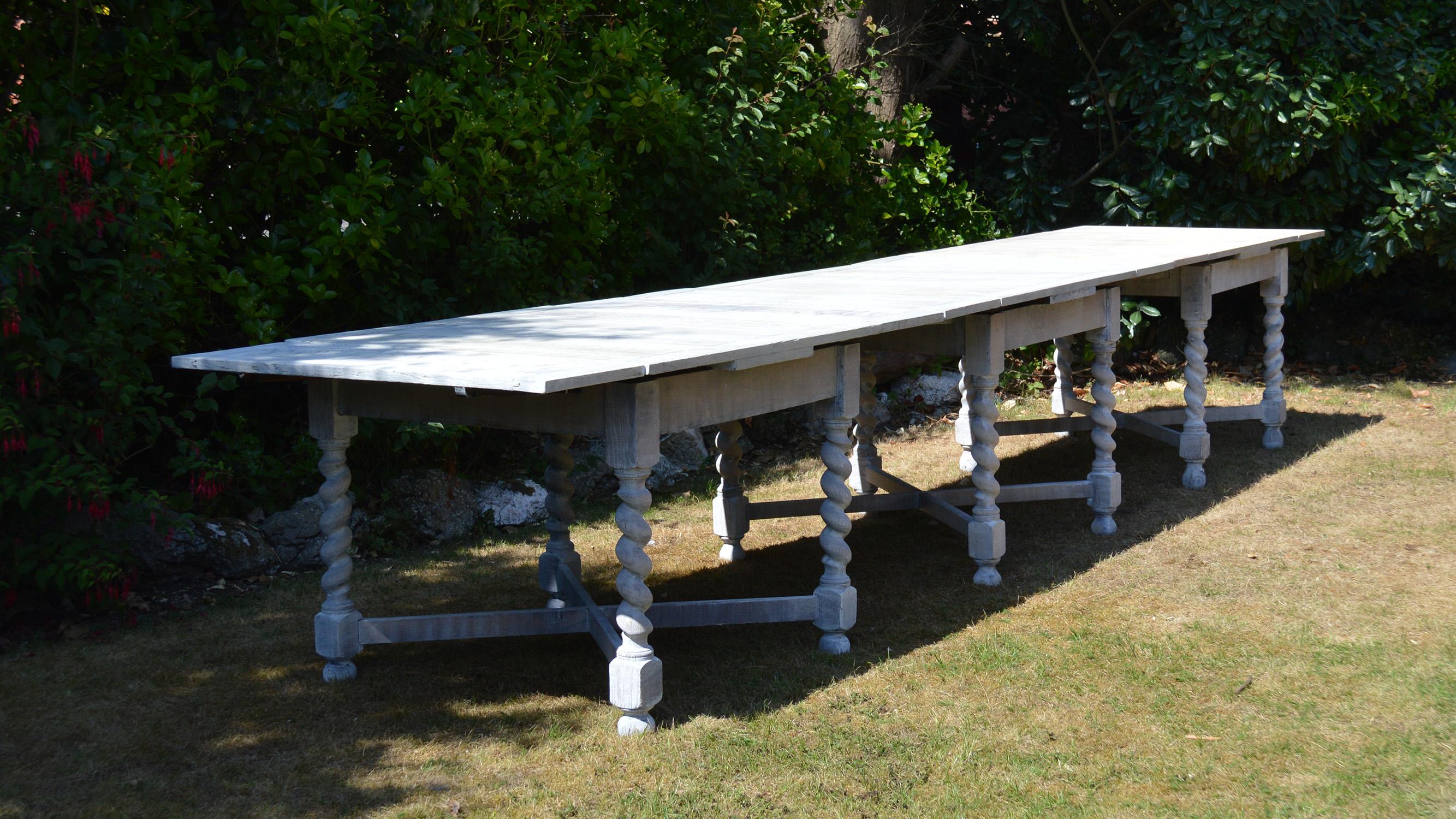 A 15 feet long informal dining table which seats 12 people comfortably.

12 twisted column supports and three stretchers.

It consists of three near matching draw leaf tables fixed together.

It has been bleached and re-limed to enhance the