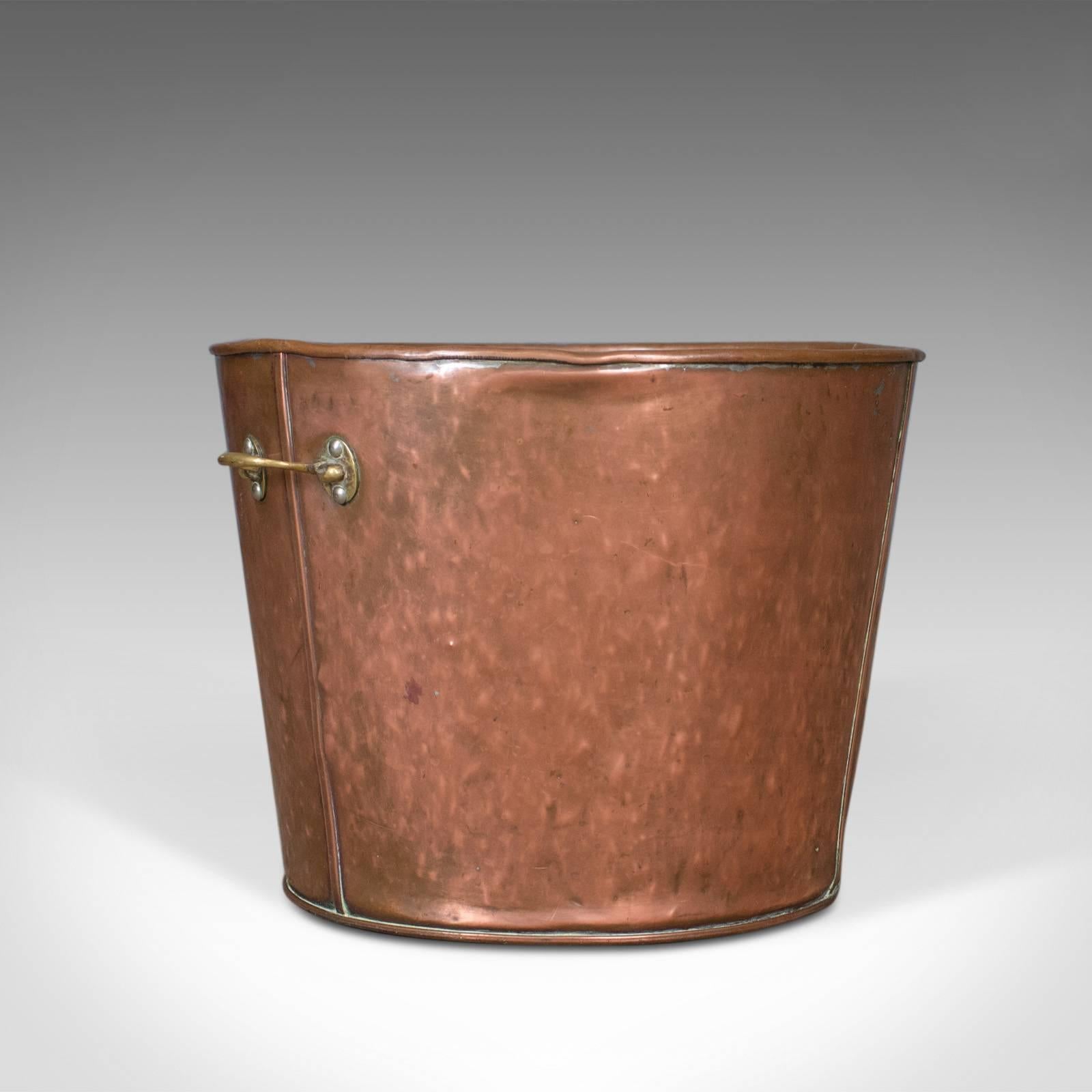 This is a large antique log bin, an English fireside scuttle in coppered finish dating to circa 1900.

A pleasing fireside storage bin presented in good antique condition
Suitable for coal, logs and kindling or helpful when removing