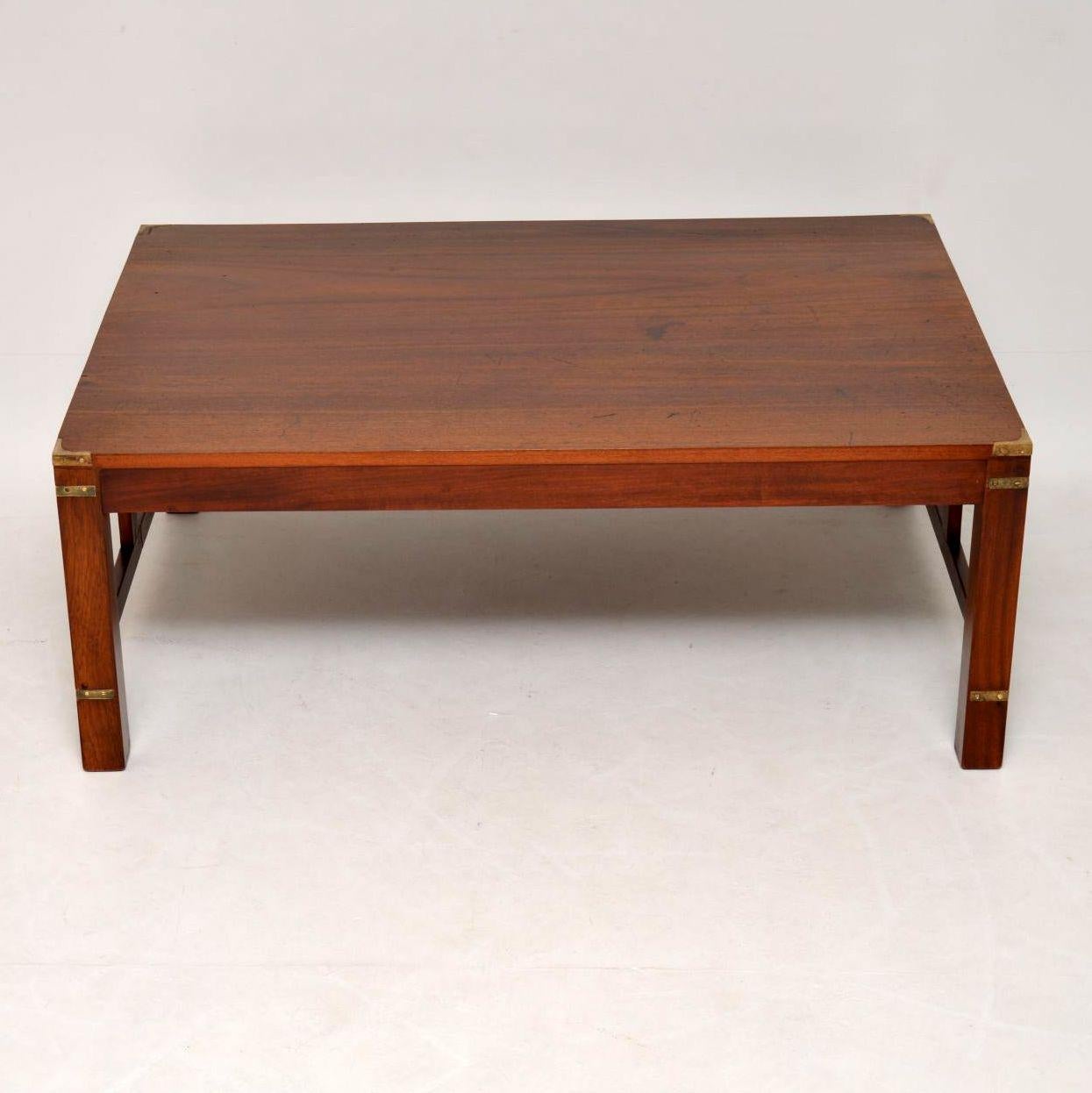 Large antique solid mahogany military style coffee table in great condition and with lots of character. It’s a very well constructed table with brass military fittings and cross stretchers between the legs and supports. I believe it has been adapted