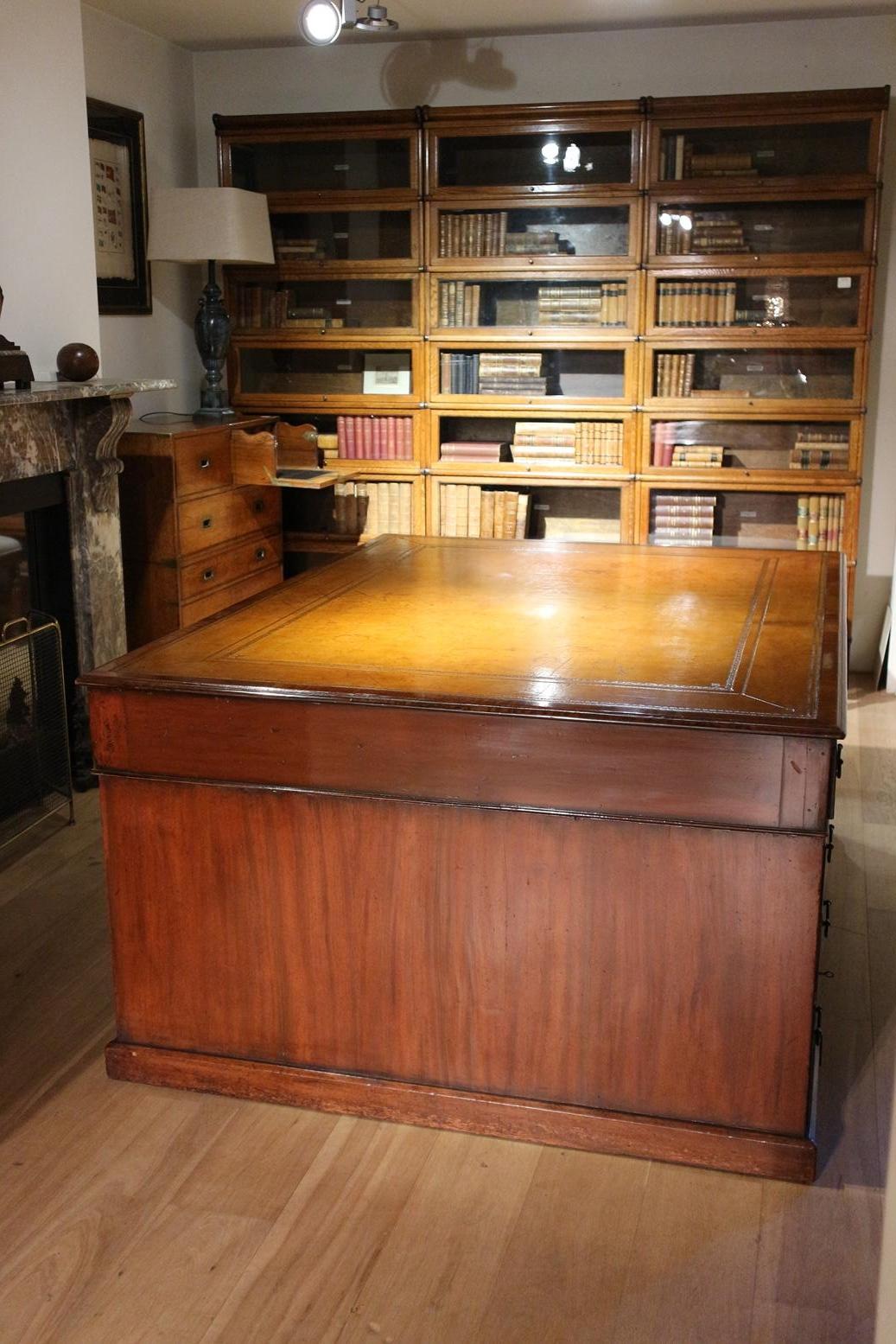 Large antique partner desk with 10 drawers on both sides. Beautiful leather tray, one-piece cowhide leather. Entire desk has a beautiful aged patina. The desks with drawers on both sides are the better versions. Drawers look nice and are practical.