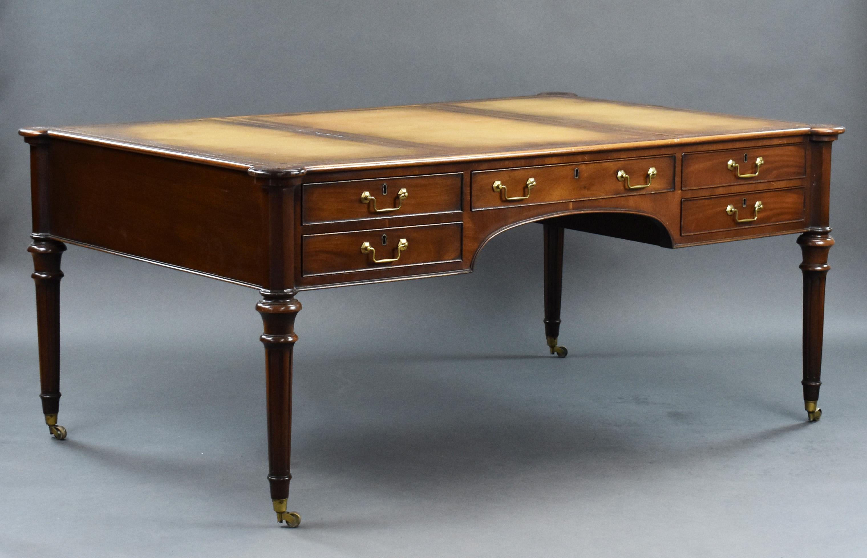 For sale is a good quality large leather top writing table by Taylor & Sons, Brompton Road, London, having three leather inserts each decorated with Greek key tooling, above an arrangement of five drawers with a further five drawers on the opposing